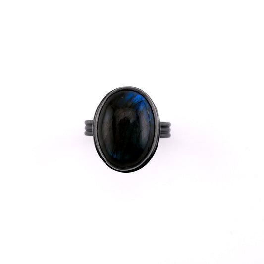 Ring with a black stone on a white background