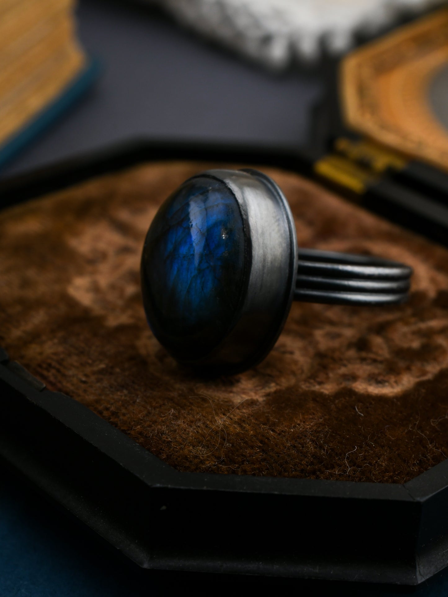 Ring with a blue gemstone on a textured surface