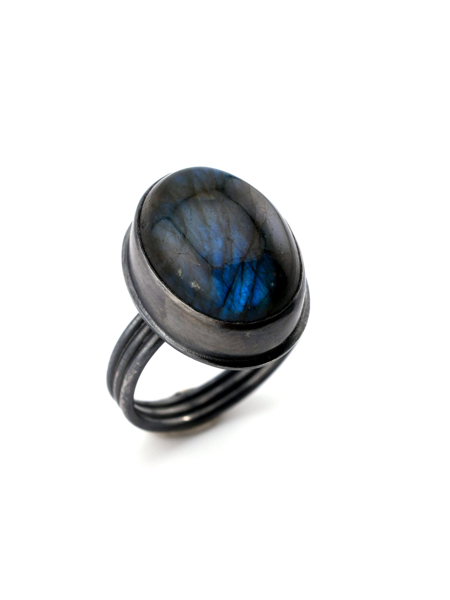 Ring with a blue oval stone on a white background