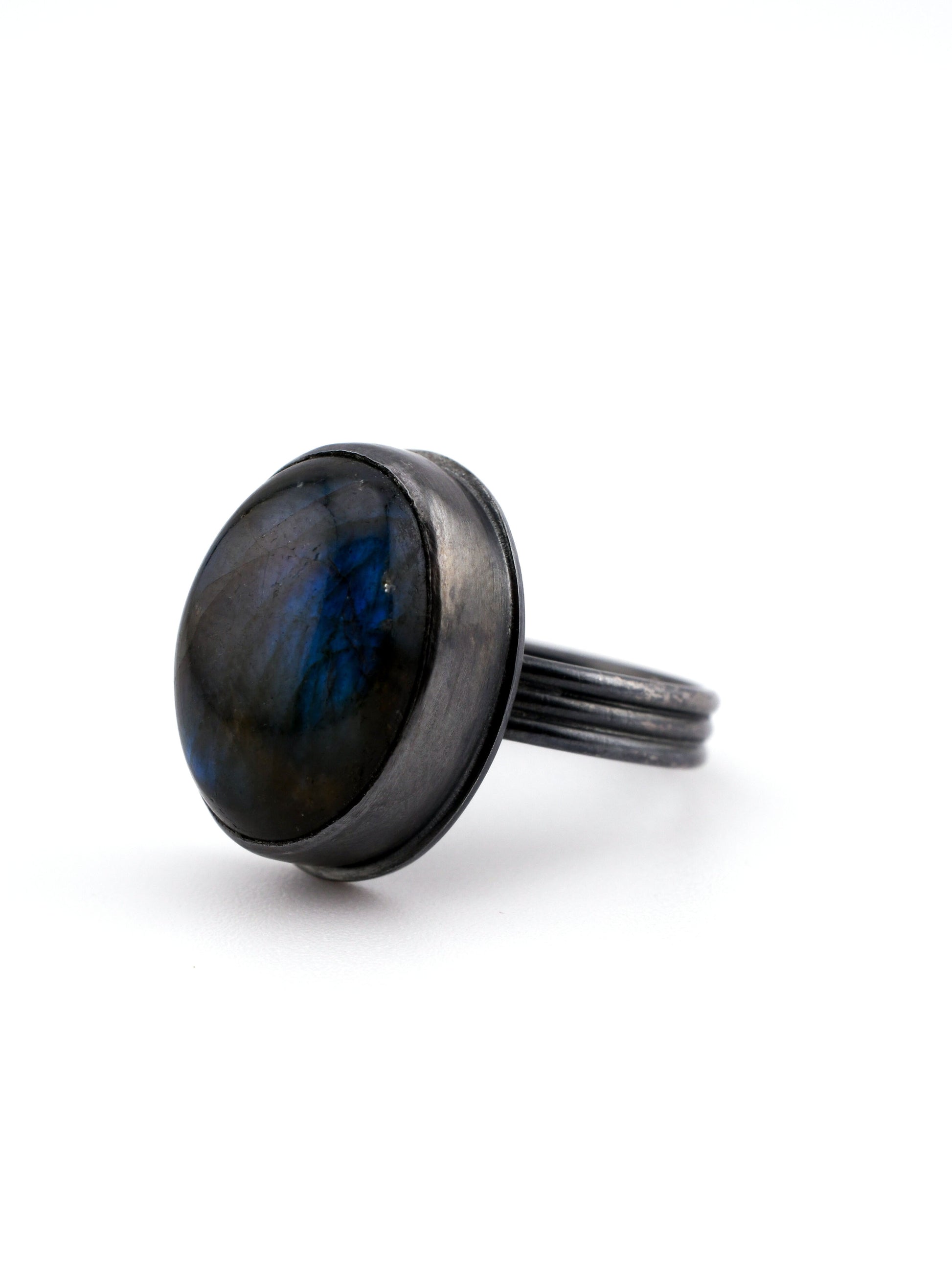 Black ring with a blue stone on a white background