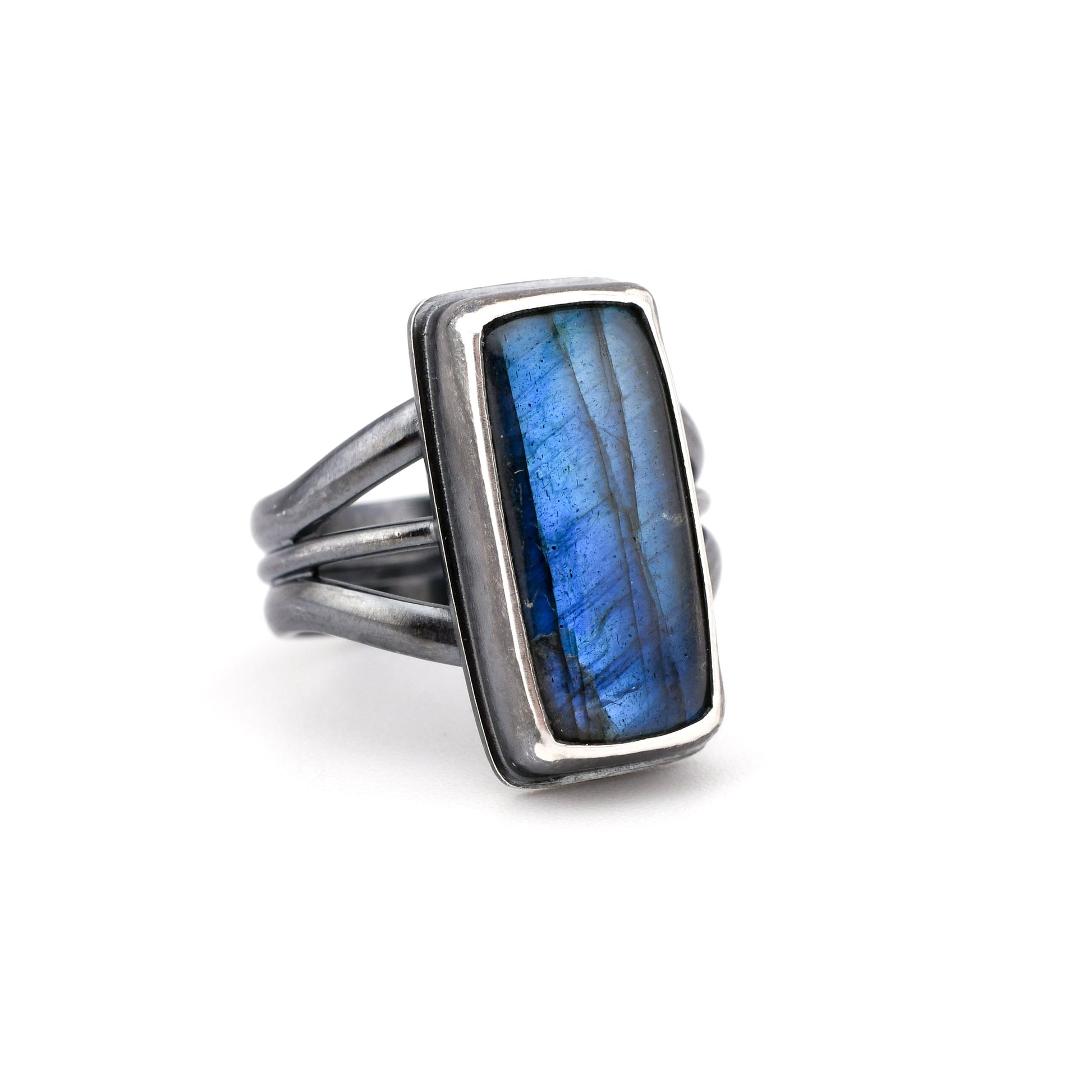 Silver ring with a blue stone on a white background