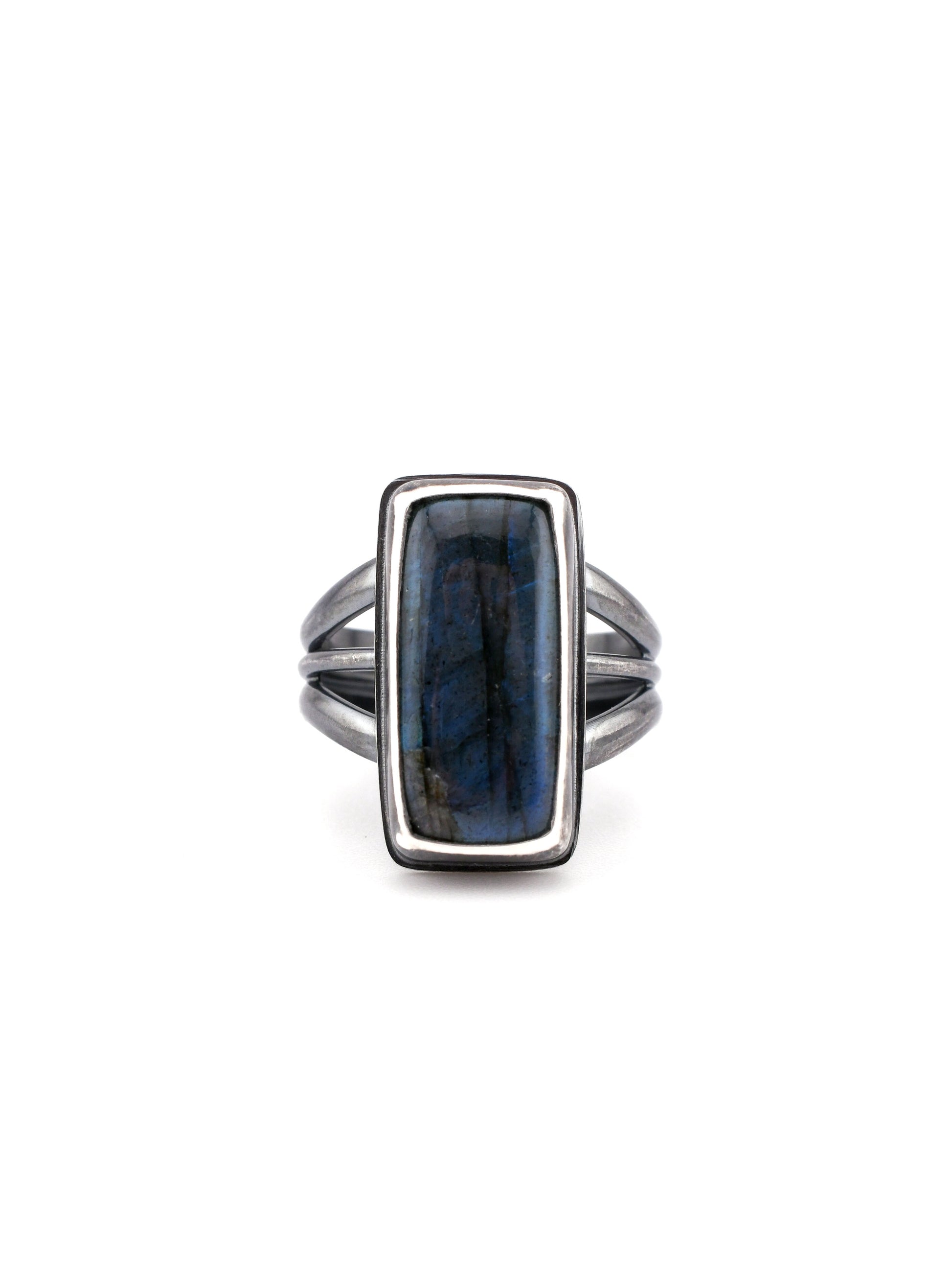Silver ring with a blue stone on a white background
