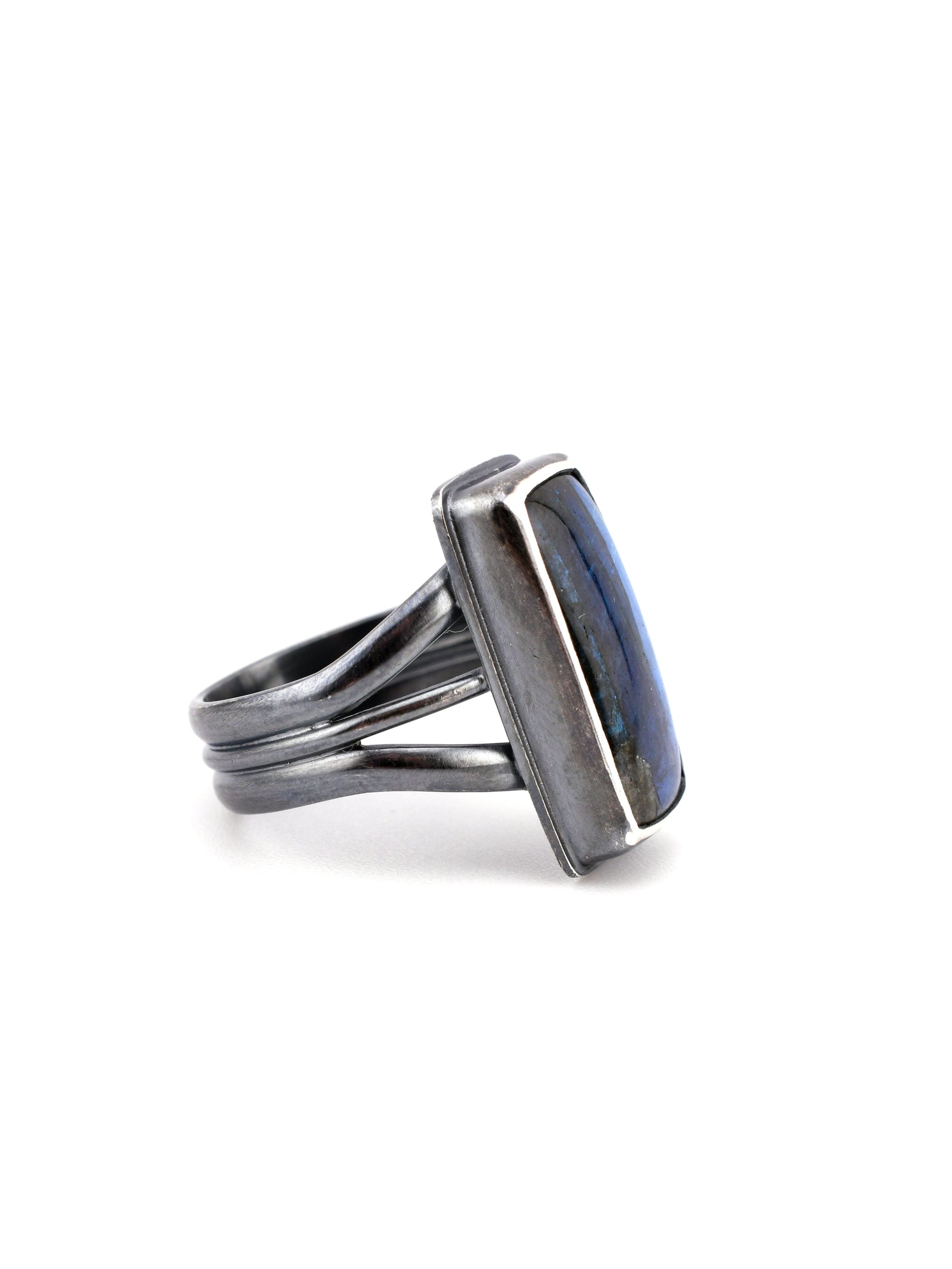 Silver ring with a rectangular stone on a white background