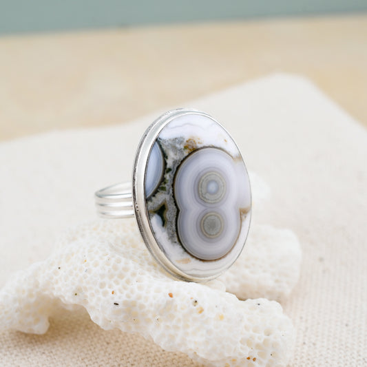 Oval ocean jasper ring on white coral