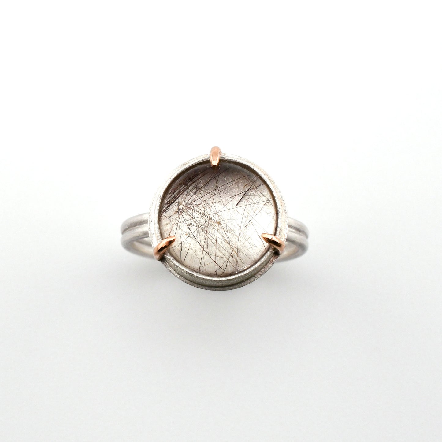 Ring with a circular stone on a white background