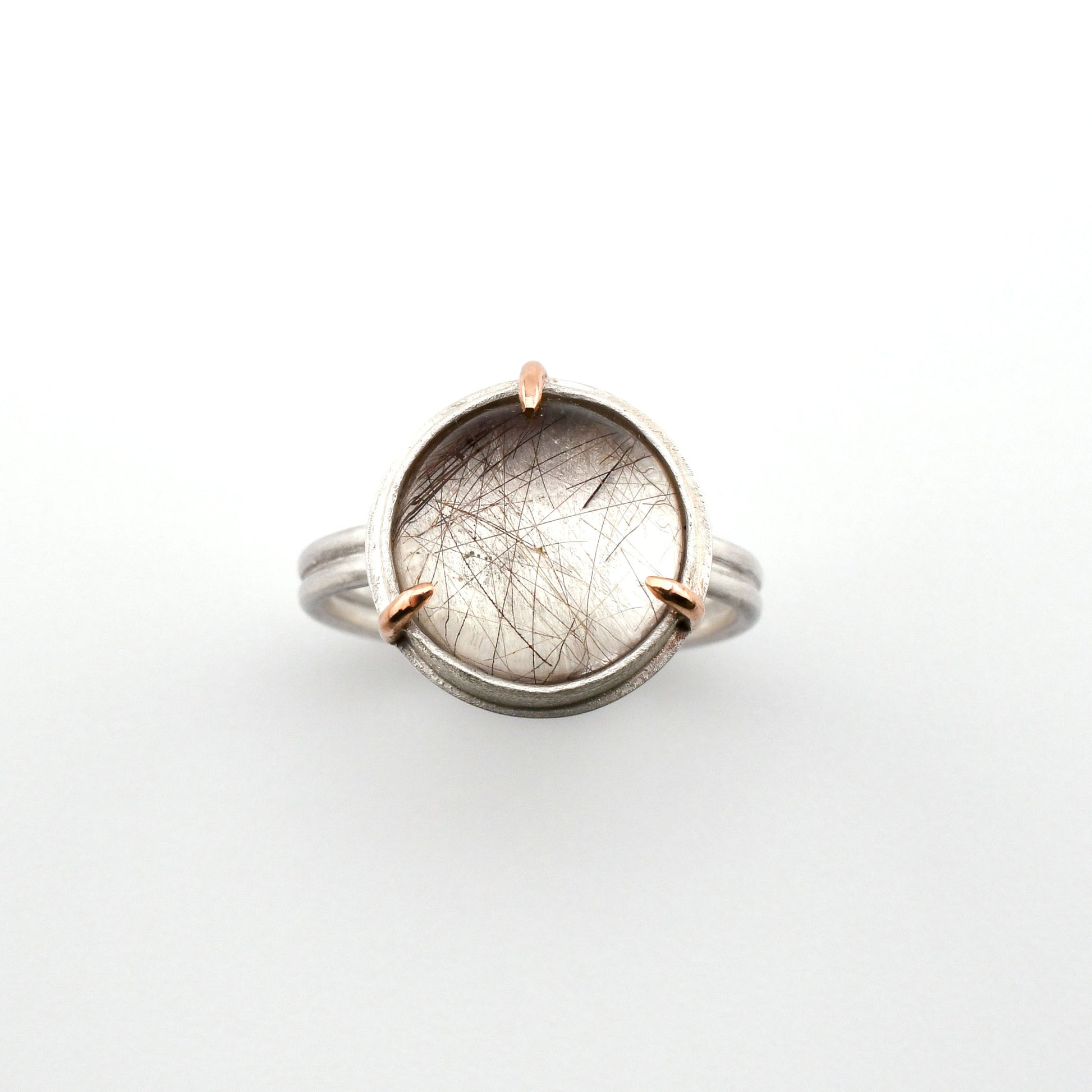 Ring with a circular stone on a white background