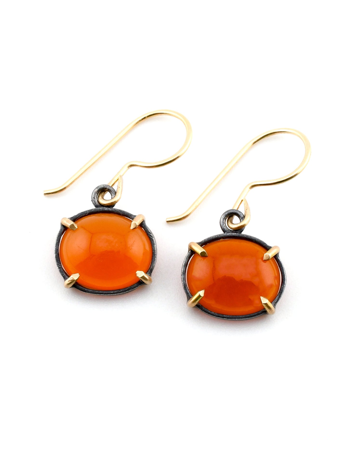 Pair of orange earrings with gold accents on a white background