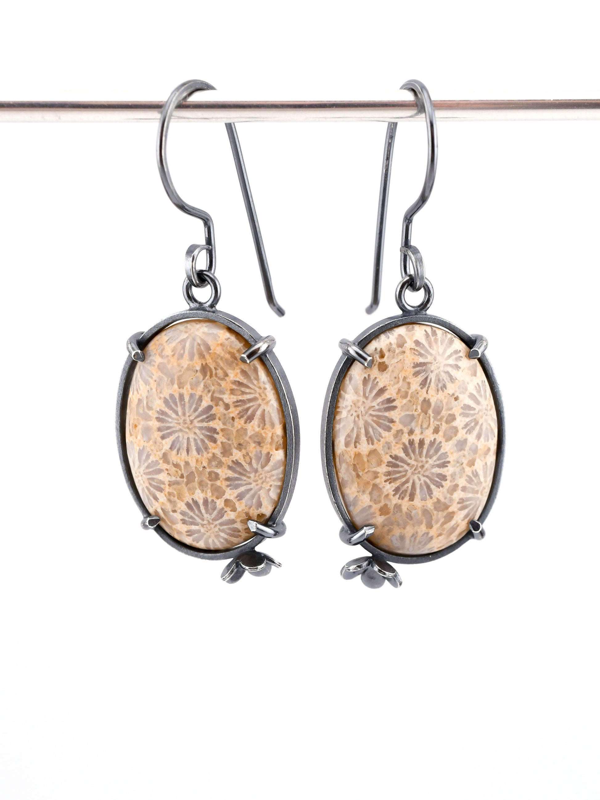 Pair of earrings with floral patterns on a white background
