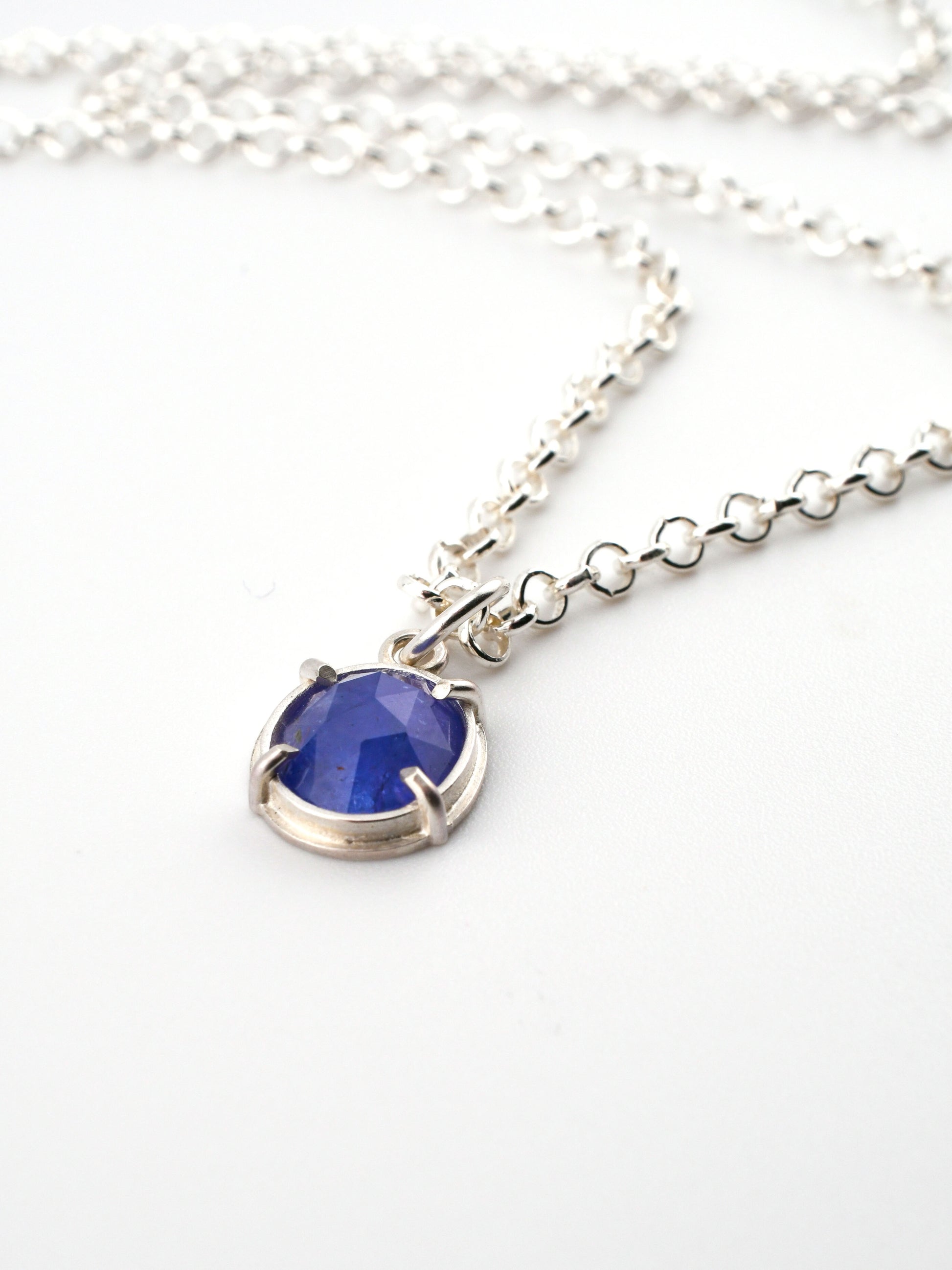 Necklace with a blue pendant on a white background