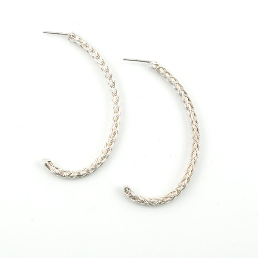 Pair of silver hoop earrings on a white background