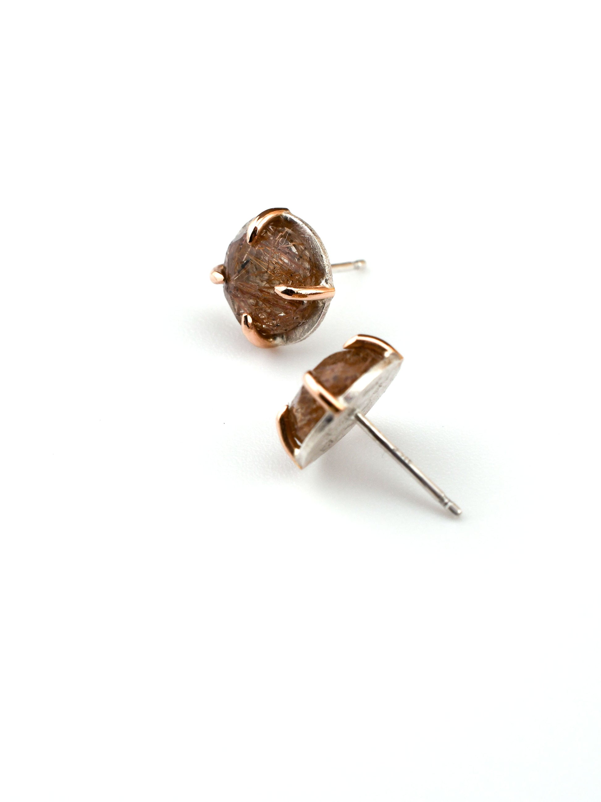 Pair of rutilated quartz stud earrings on a white background