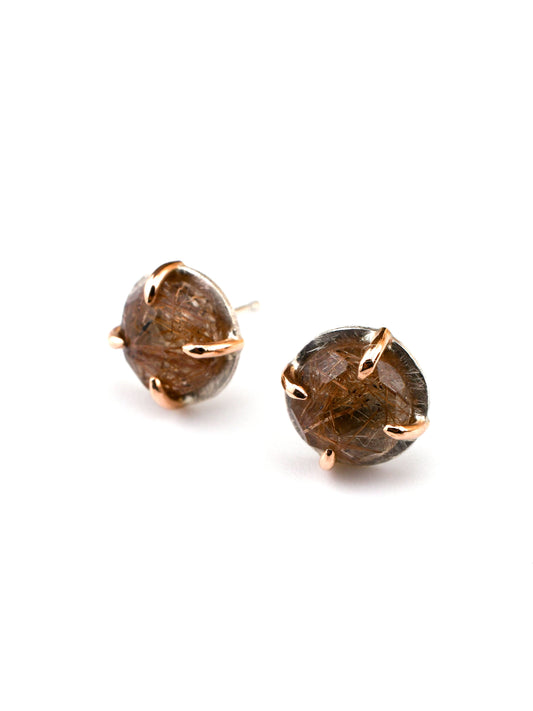 Pair of round rutilated quartz gemstone earrings with rose gold settings on a white background
