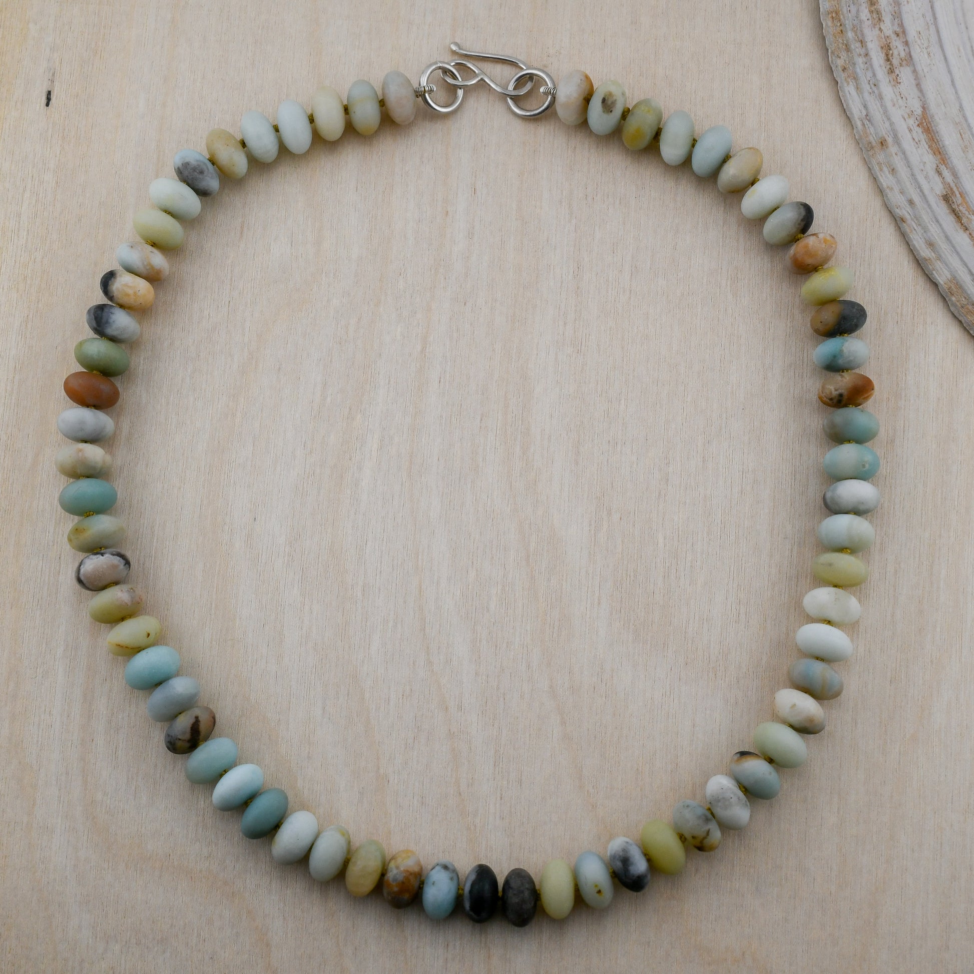 Necklace with multicolored beads on a wooden surface