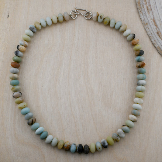 Necklace with multicolored beads on a wooden surface
