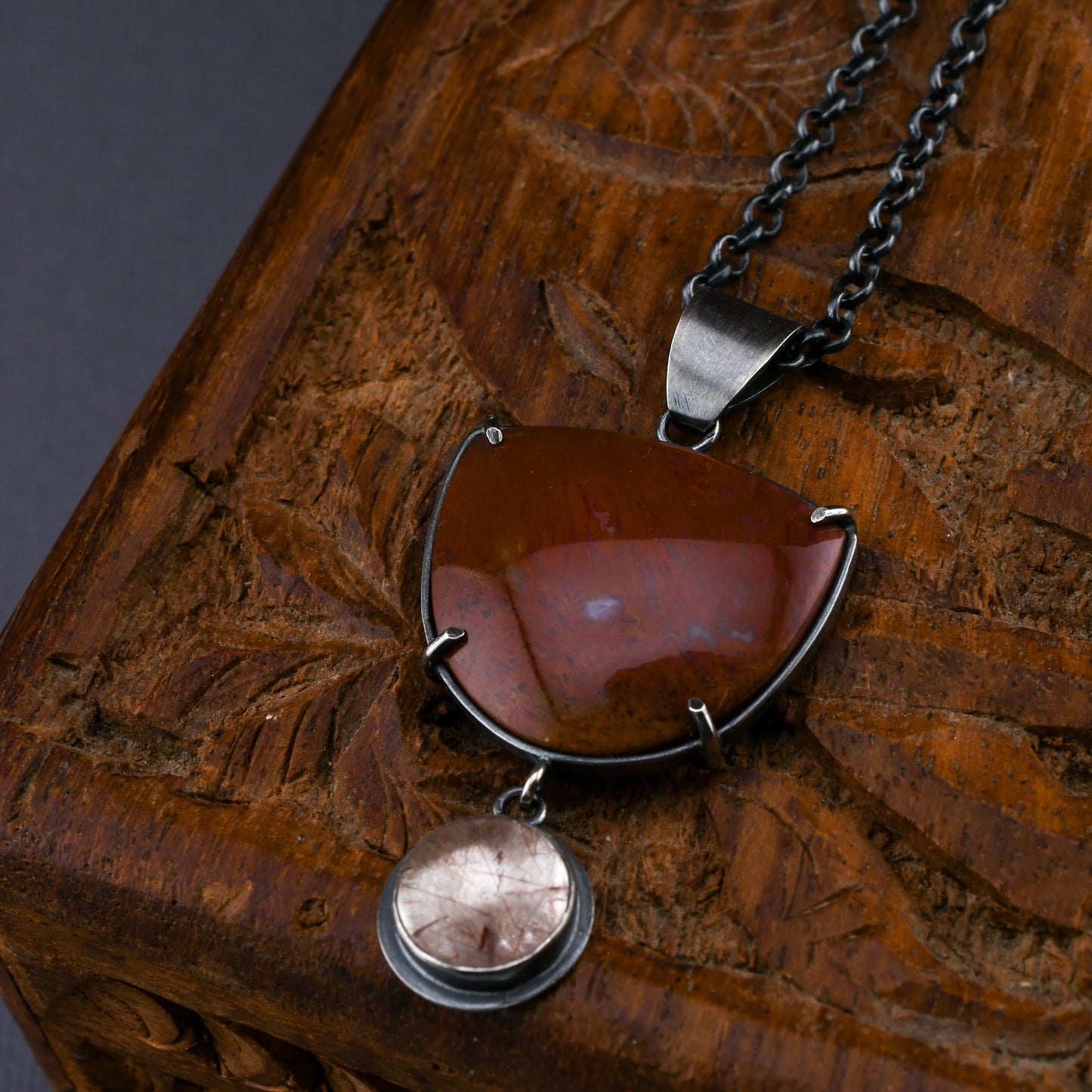Necklace with a pendant on a wooden surface