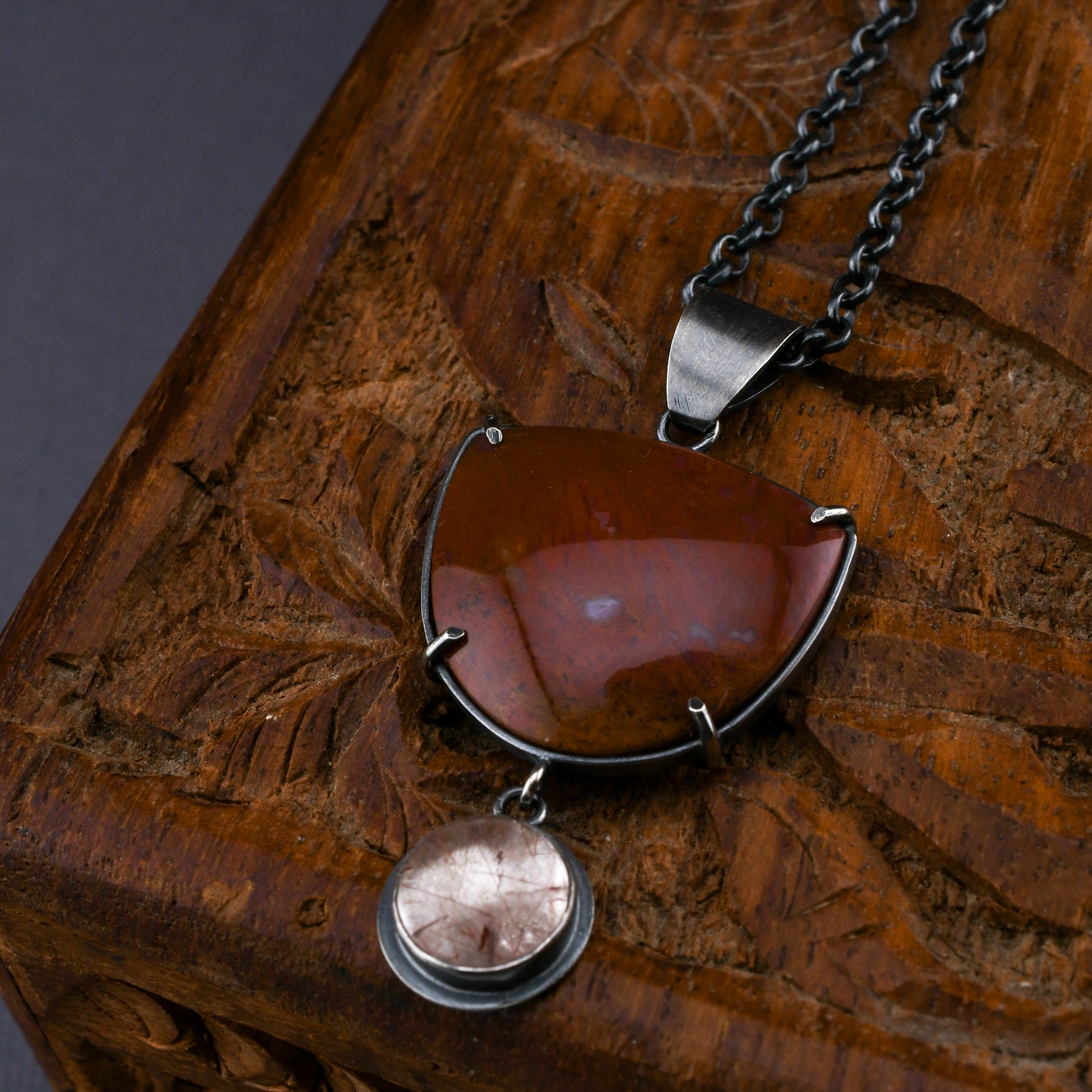 Necklace with a pendant on a wooden surface