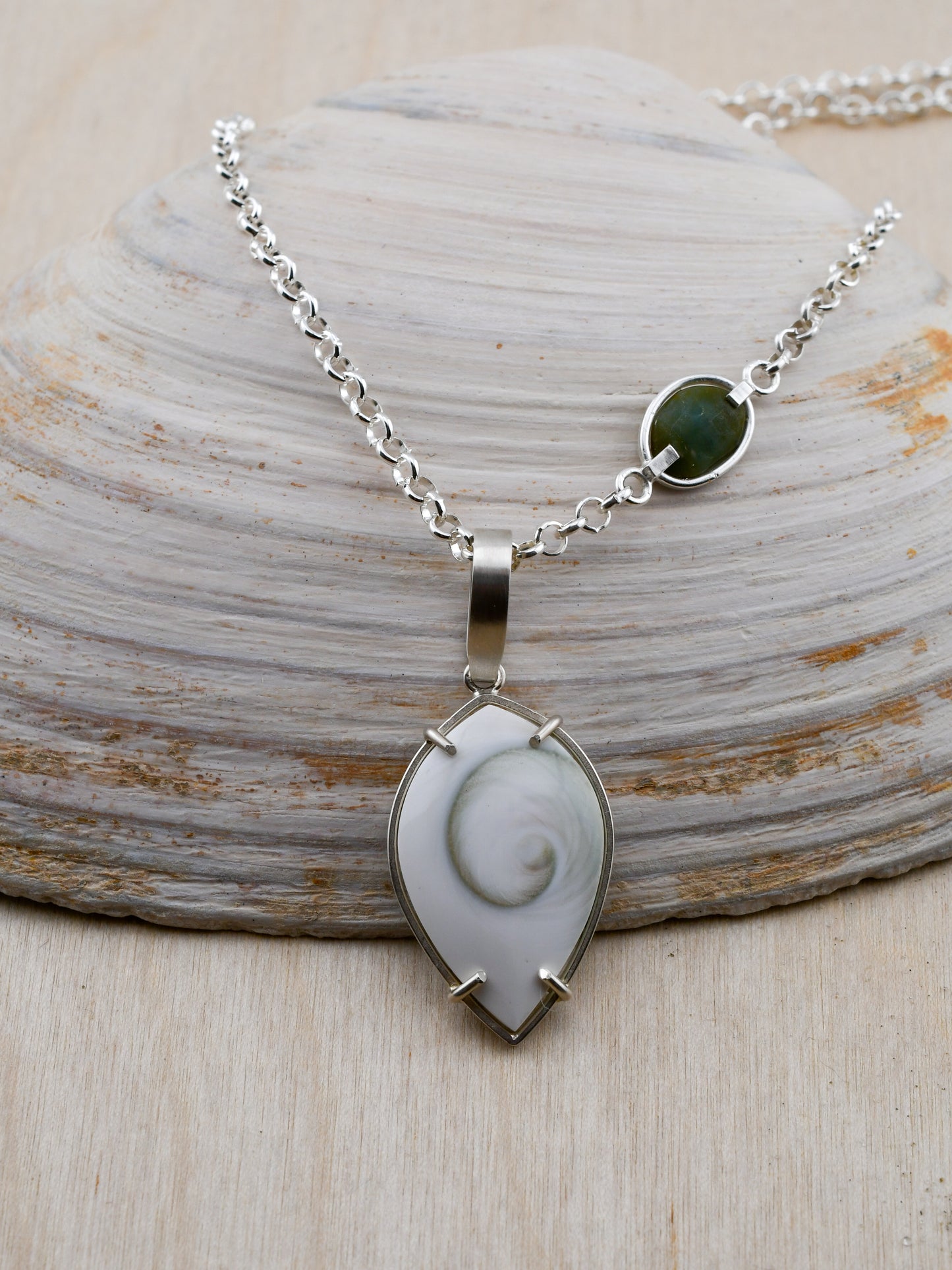 Necklace with a pendant on a shell background