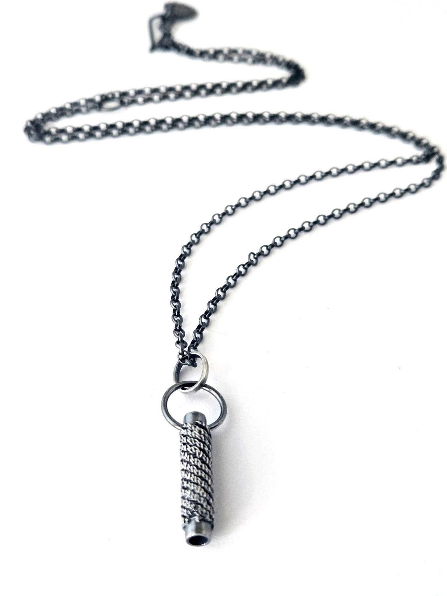 Silver pendant necklace on a white background