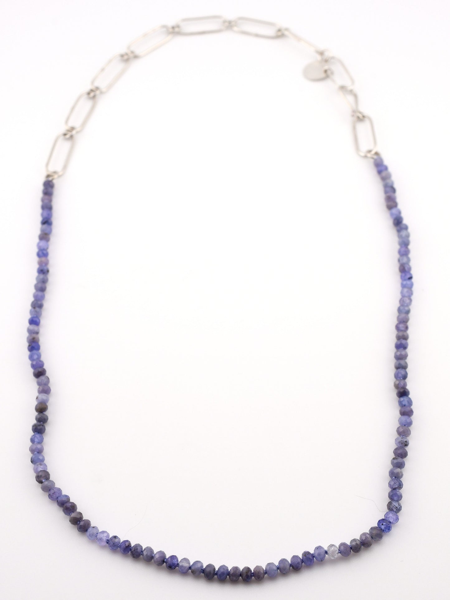 Necklace with blue beads and silver chain on a white background