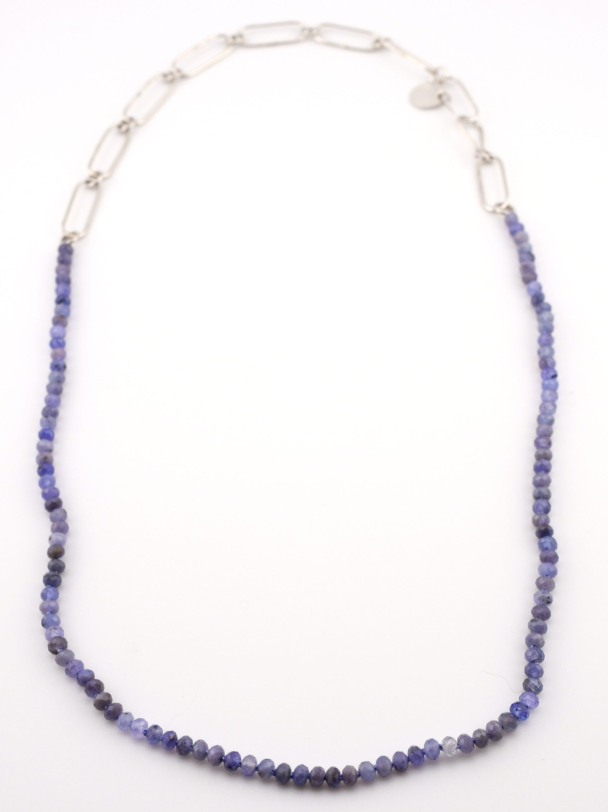 Necklace with blue beads and silver chain on a white background