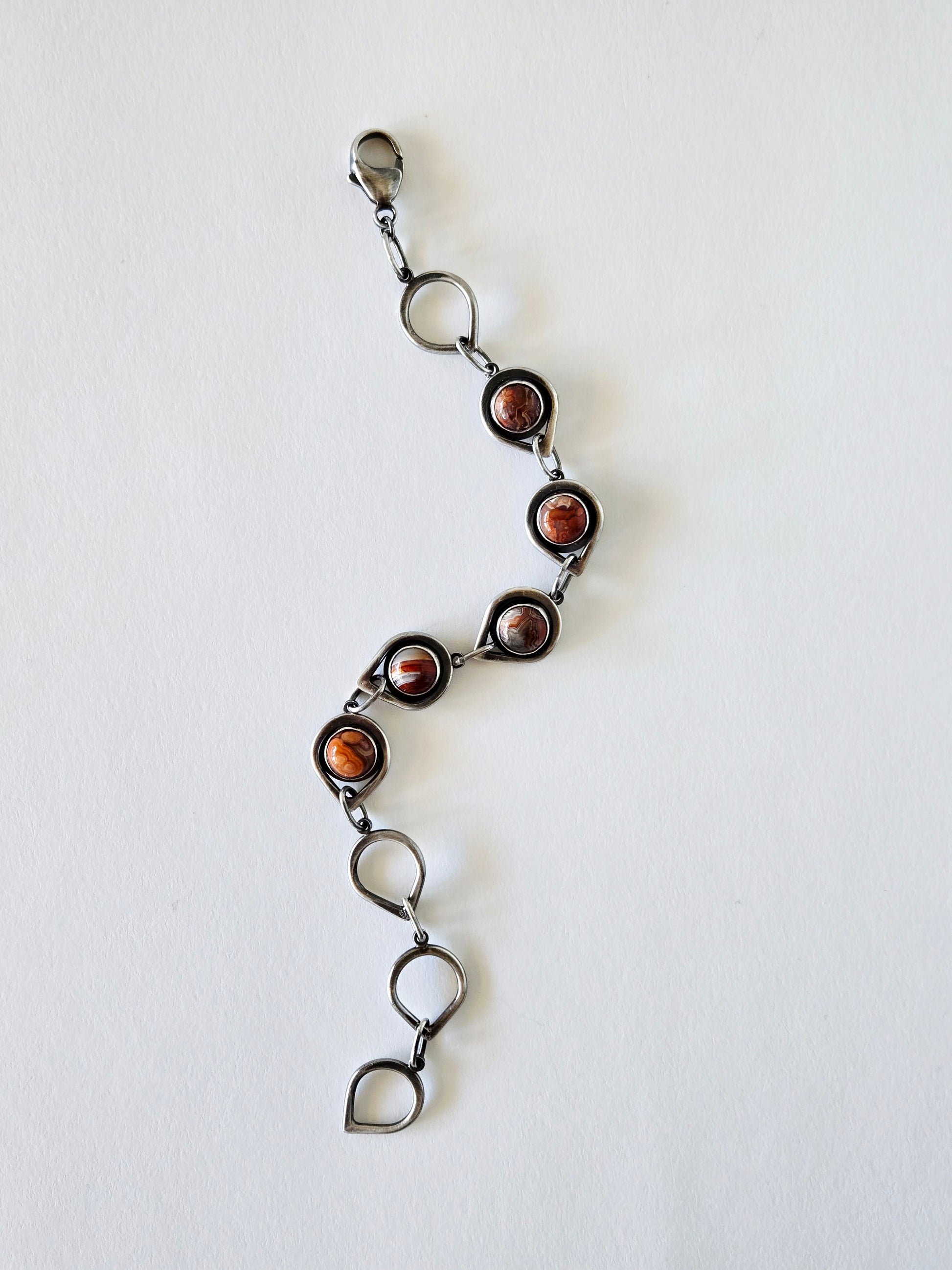 Silver and agate bracelet shown extended on a white background