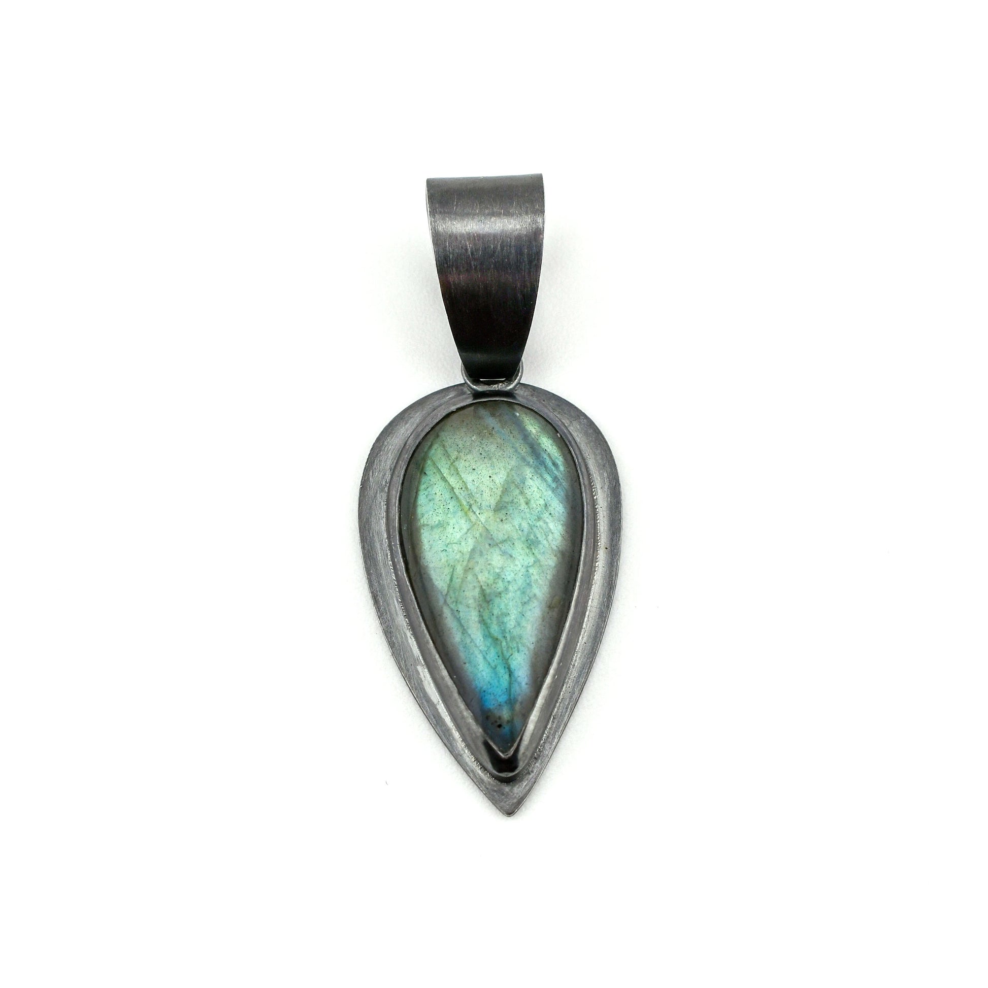Teardrop-shaped pendant with a labradorite stone on a white background