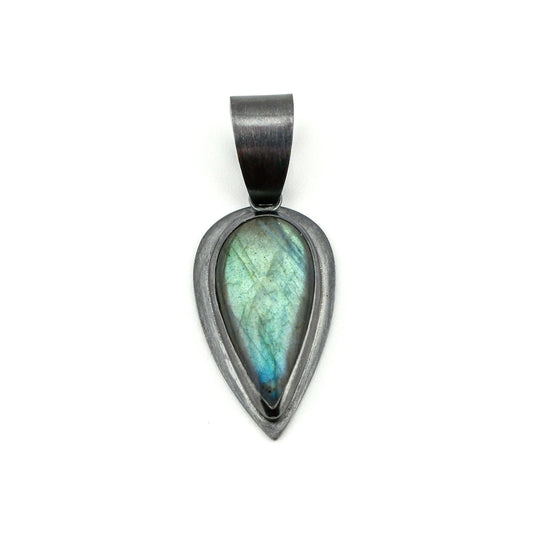 Teardrop-shaped pendant with a labradorite stone on a white background