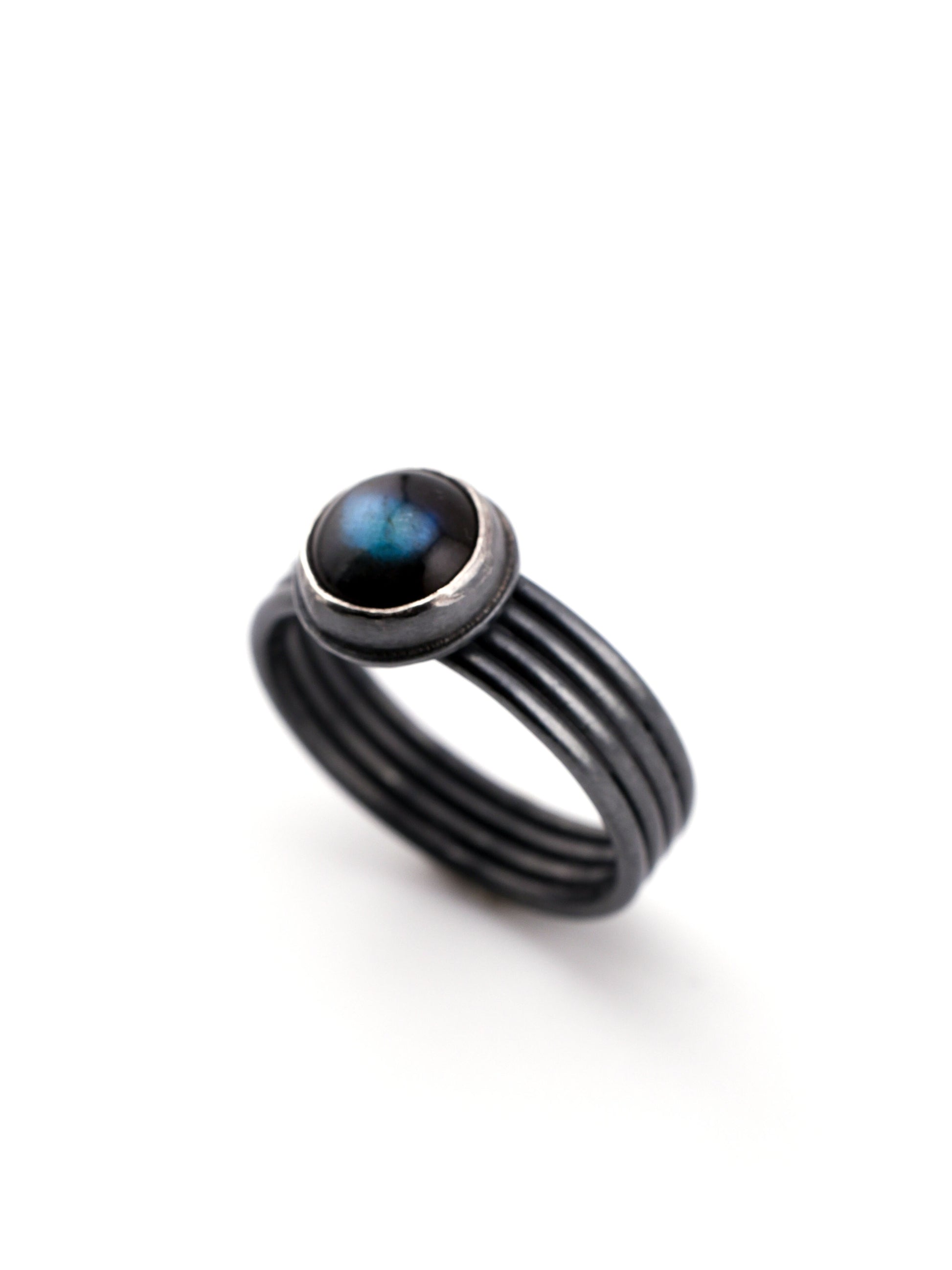 Black ring with a blue stone on a white background