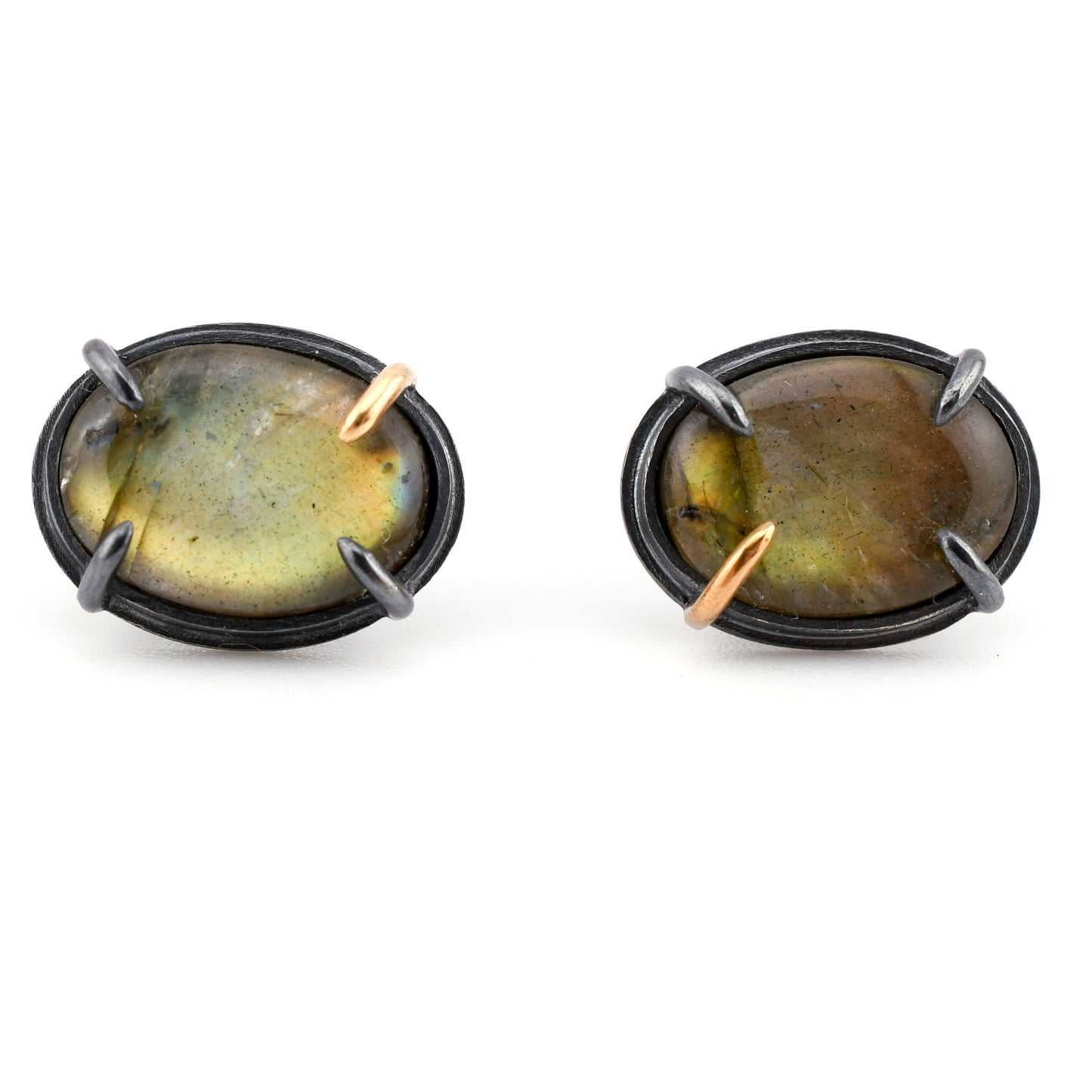 Pair of earrings with oval gemstones and metallic accents on a white background