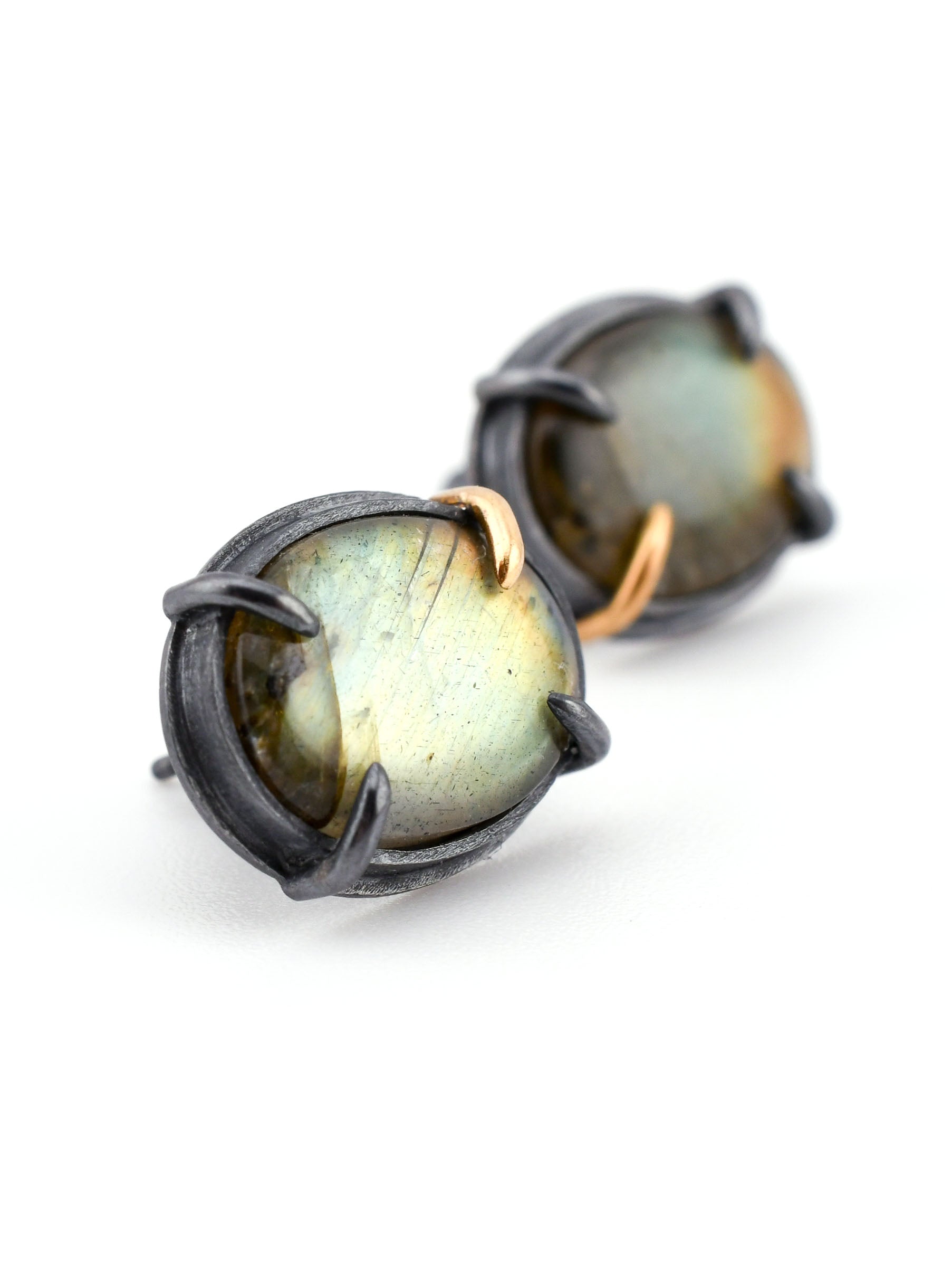 Pair of labradorite earrings with black metal setting on a white background