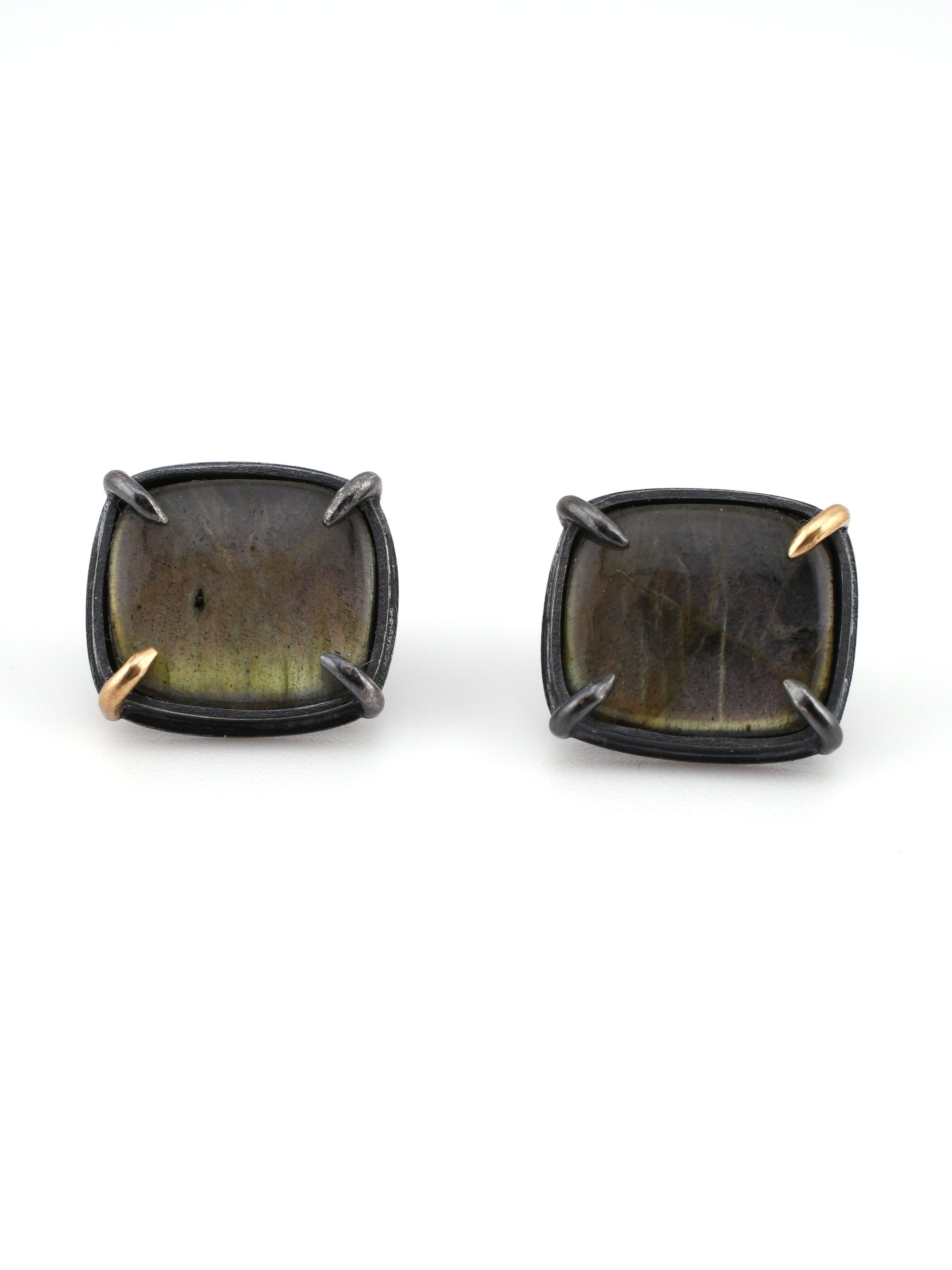 Pair of square-shaped earrings with gold accents on a white background