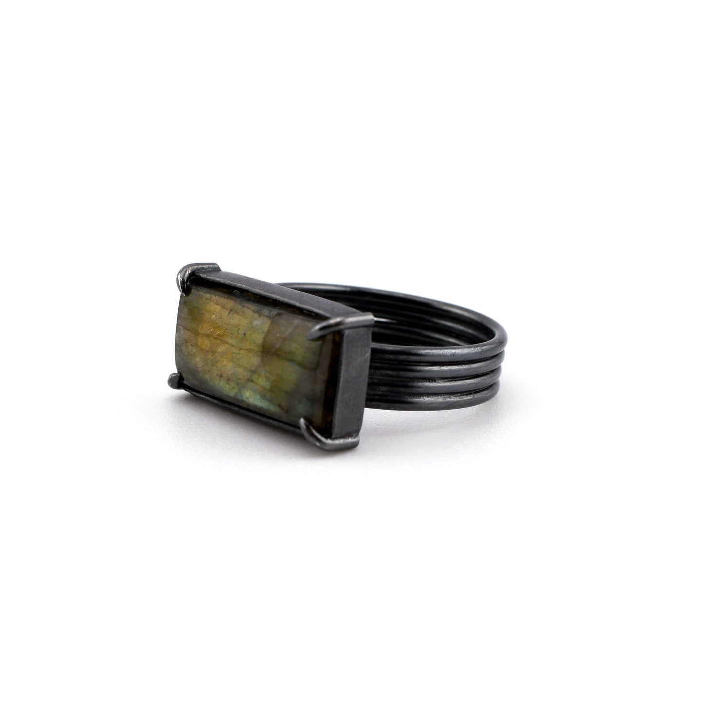 Black band ring with a rectangular stone on a white background
