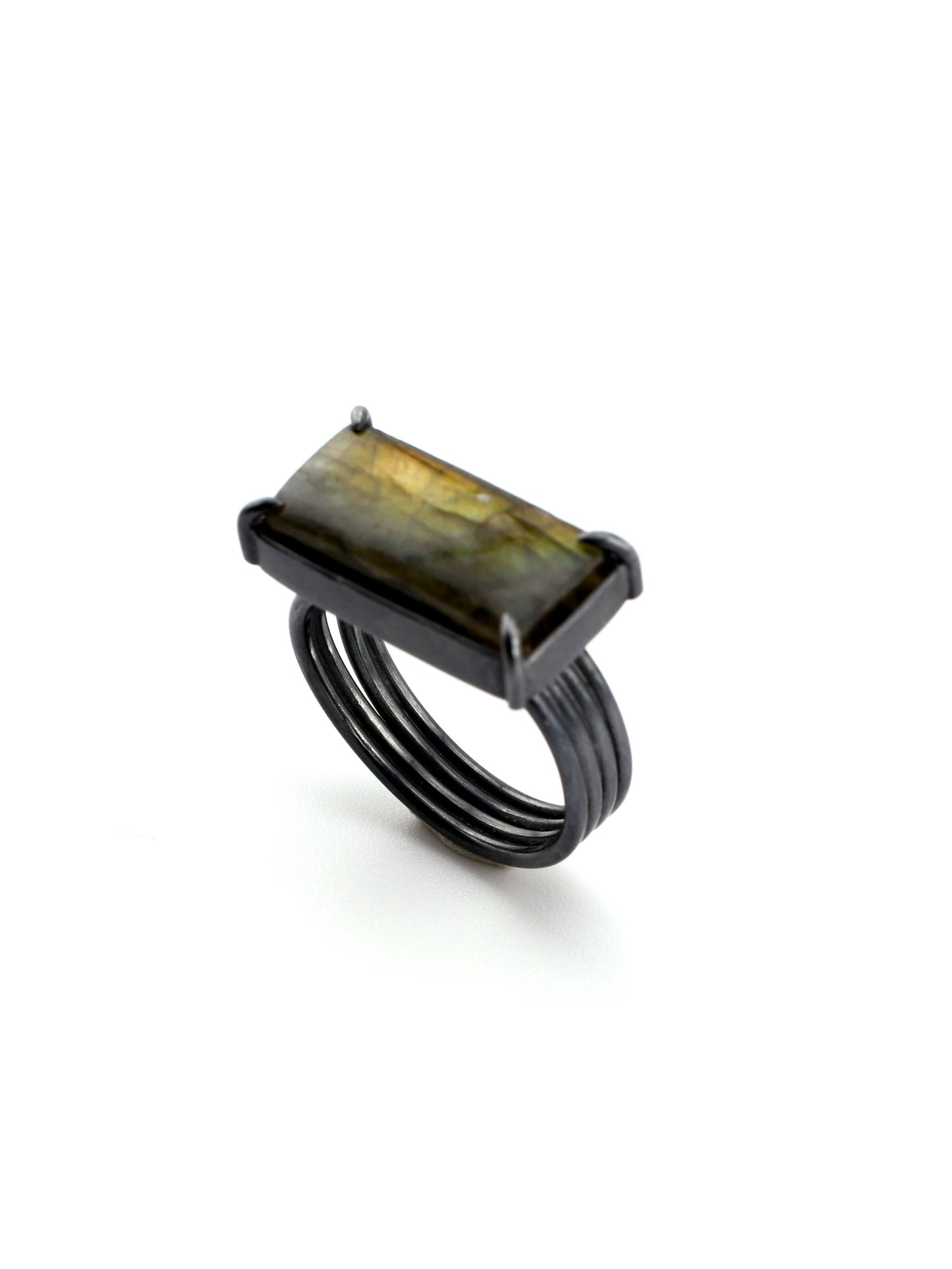 Ring with a rectangular gemstone on a white background