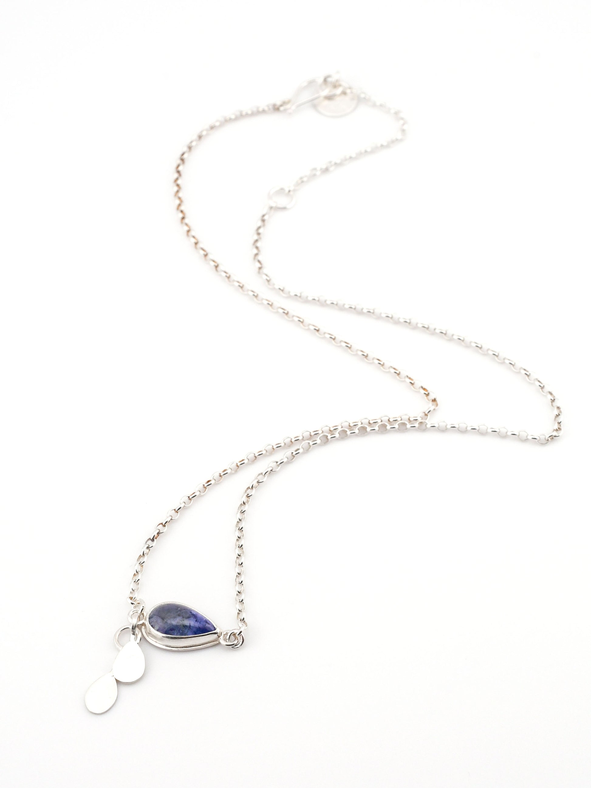 Necklace with a blue teardrop pendant on a white background