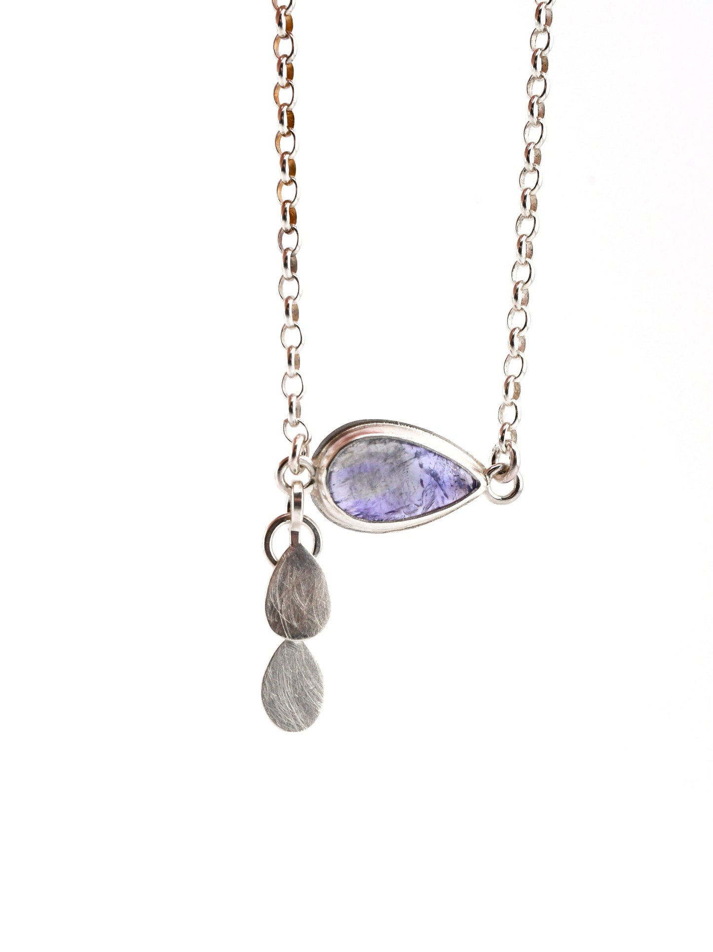 Necklace with a teardrop-shaped purple gemstone and two silver pendants on a white background