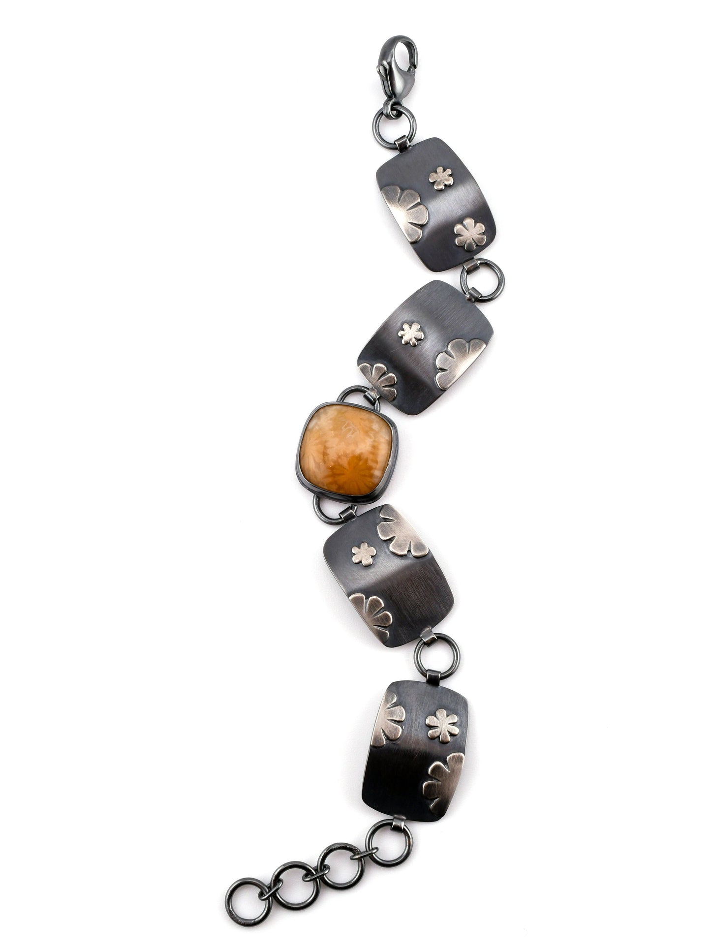 Linked bracelet with square center stone on a white background