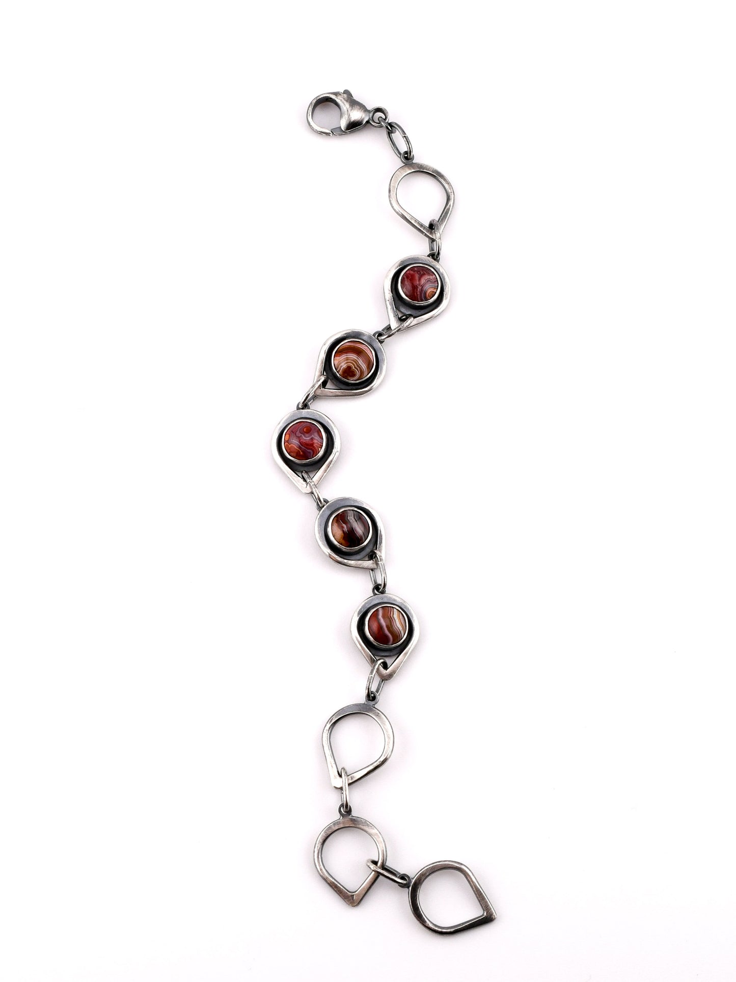 Silver bracelet with red stones on a white background