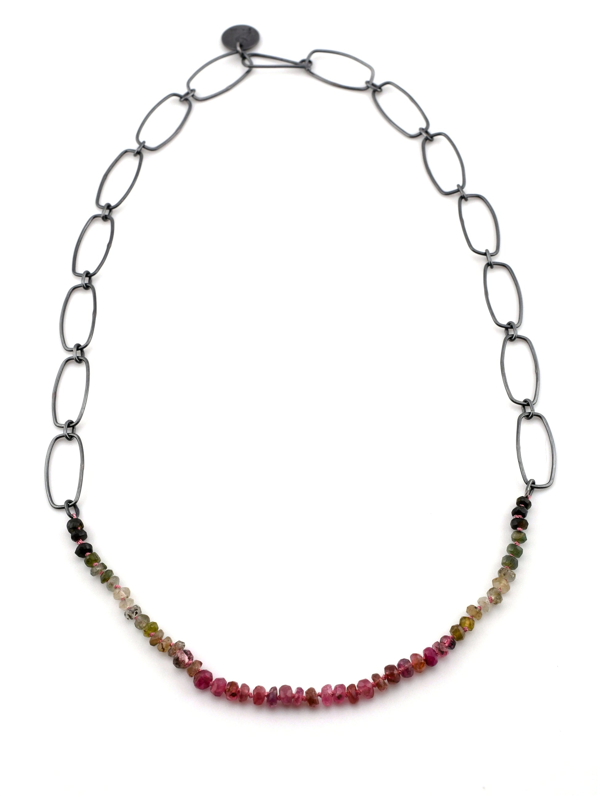 Necklace with multicolored beads on an oval chain against a white background