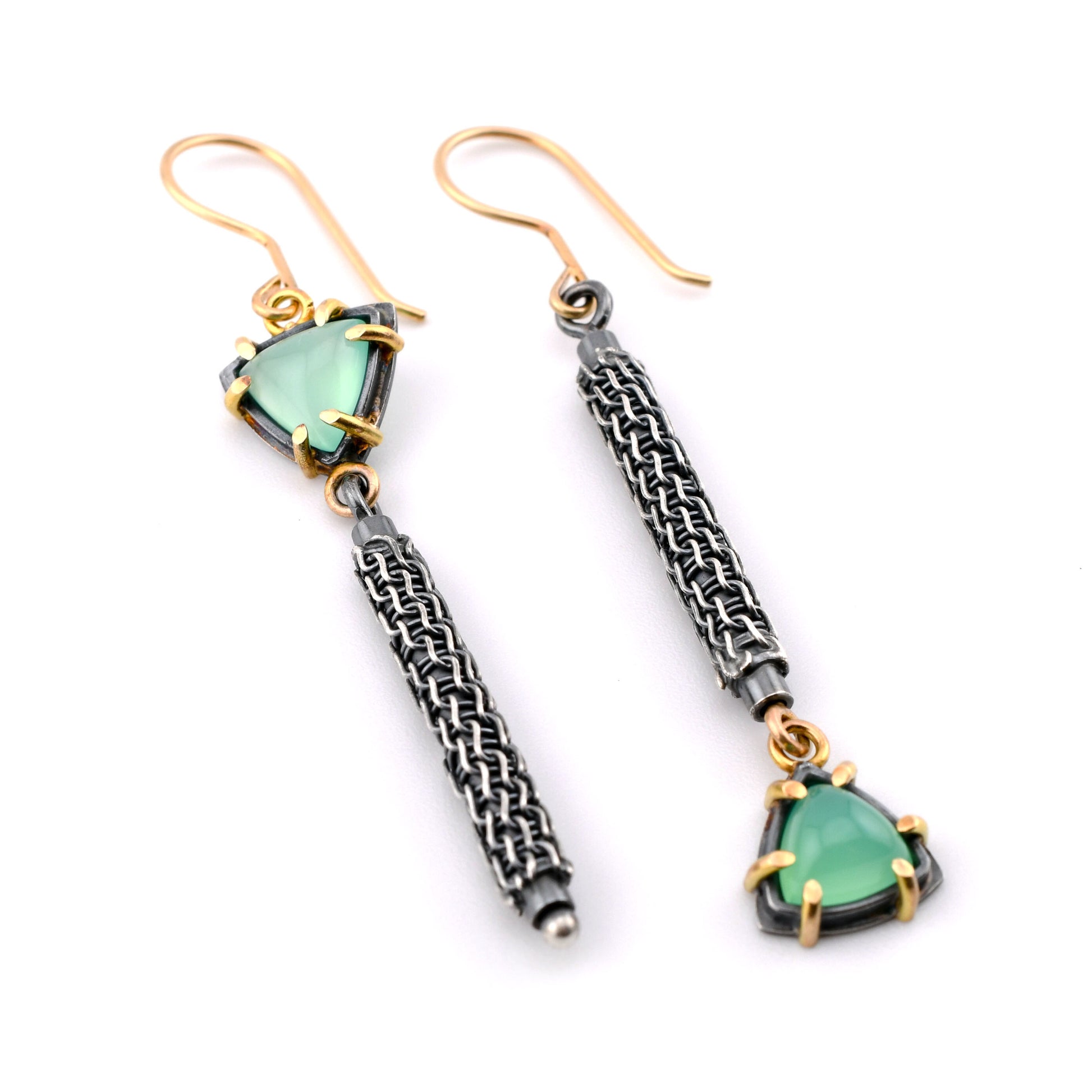 Textured silver and green stone earrings with gold accents on a white background