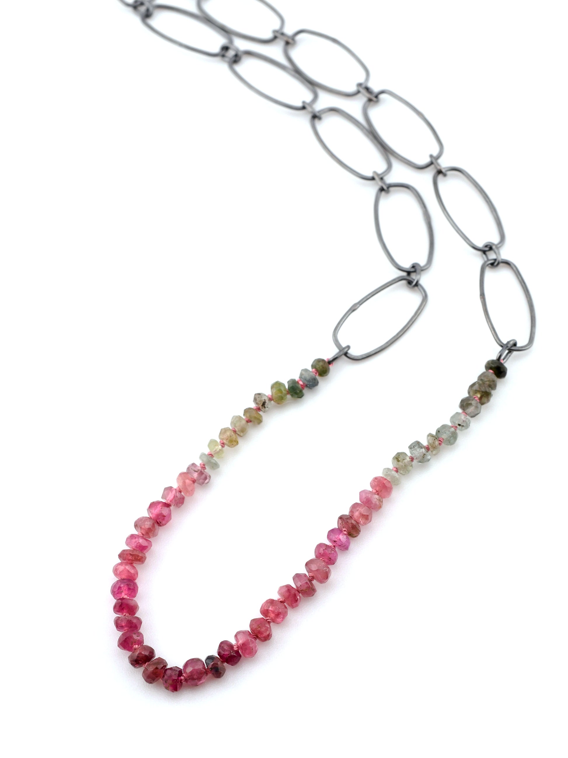 Necklace with multicolored beads and silver chain on a white background