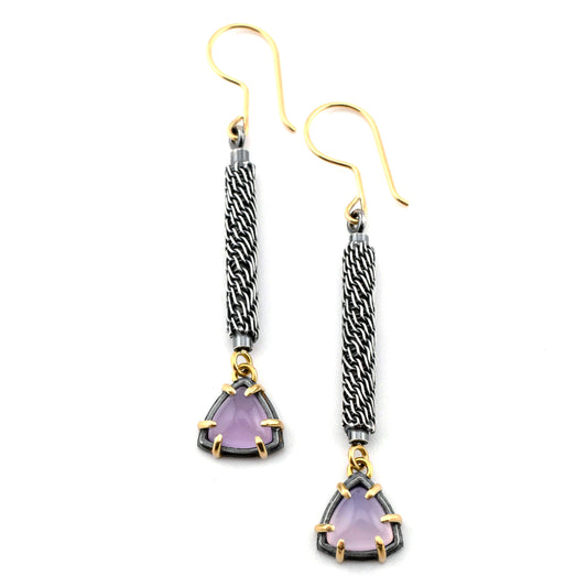 Pair of earrings with purple triangle stones and gold accents on a white background