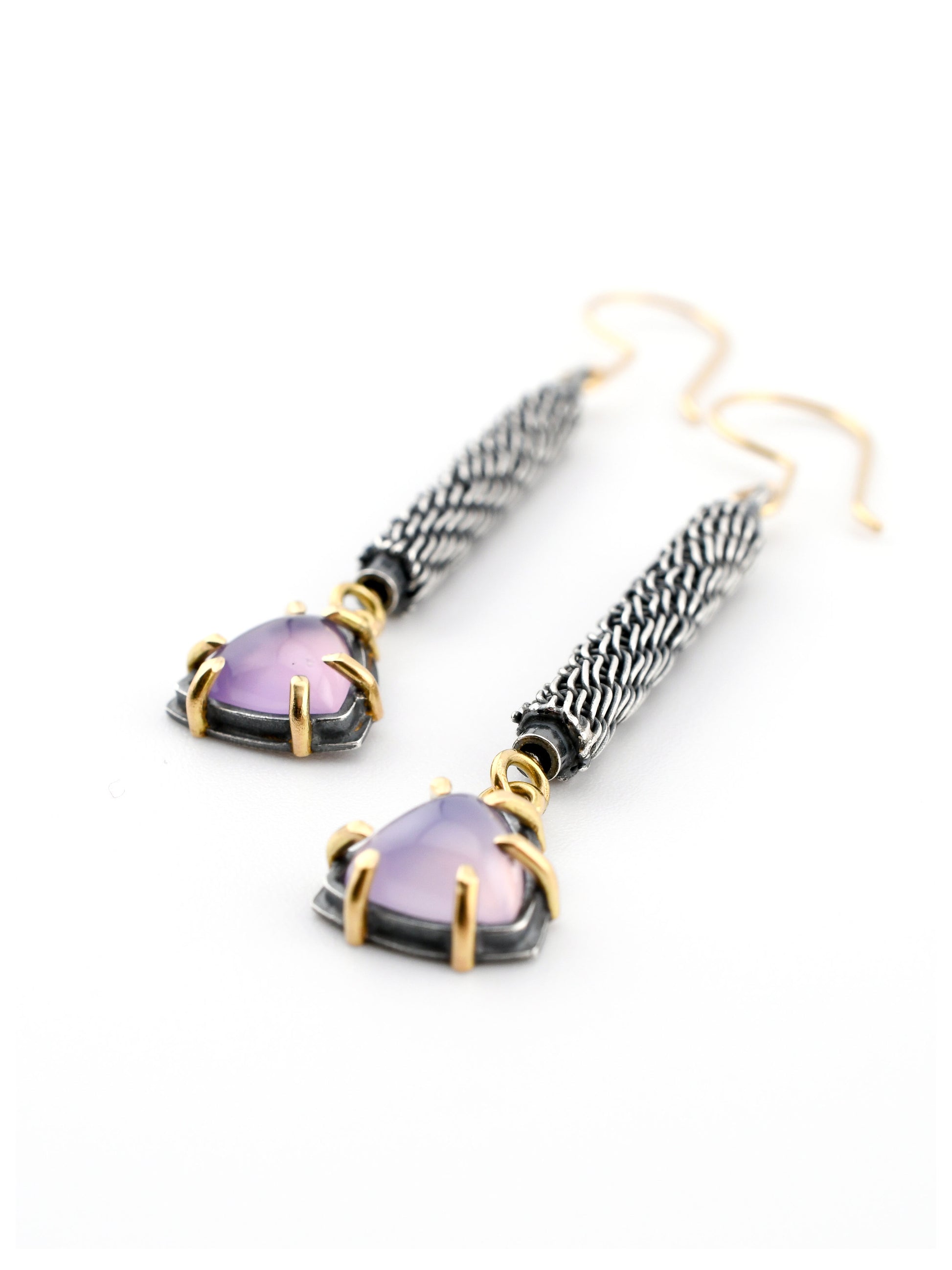 purple gemstone and textured silver earrings with gold accents on a white background
