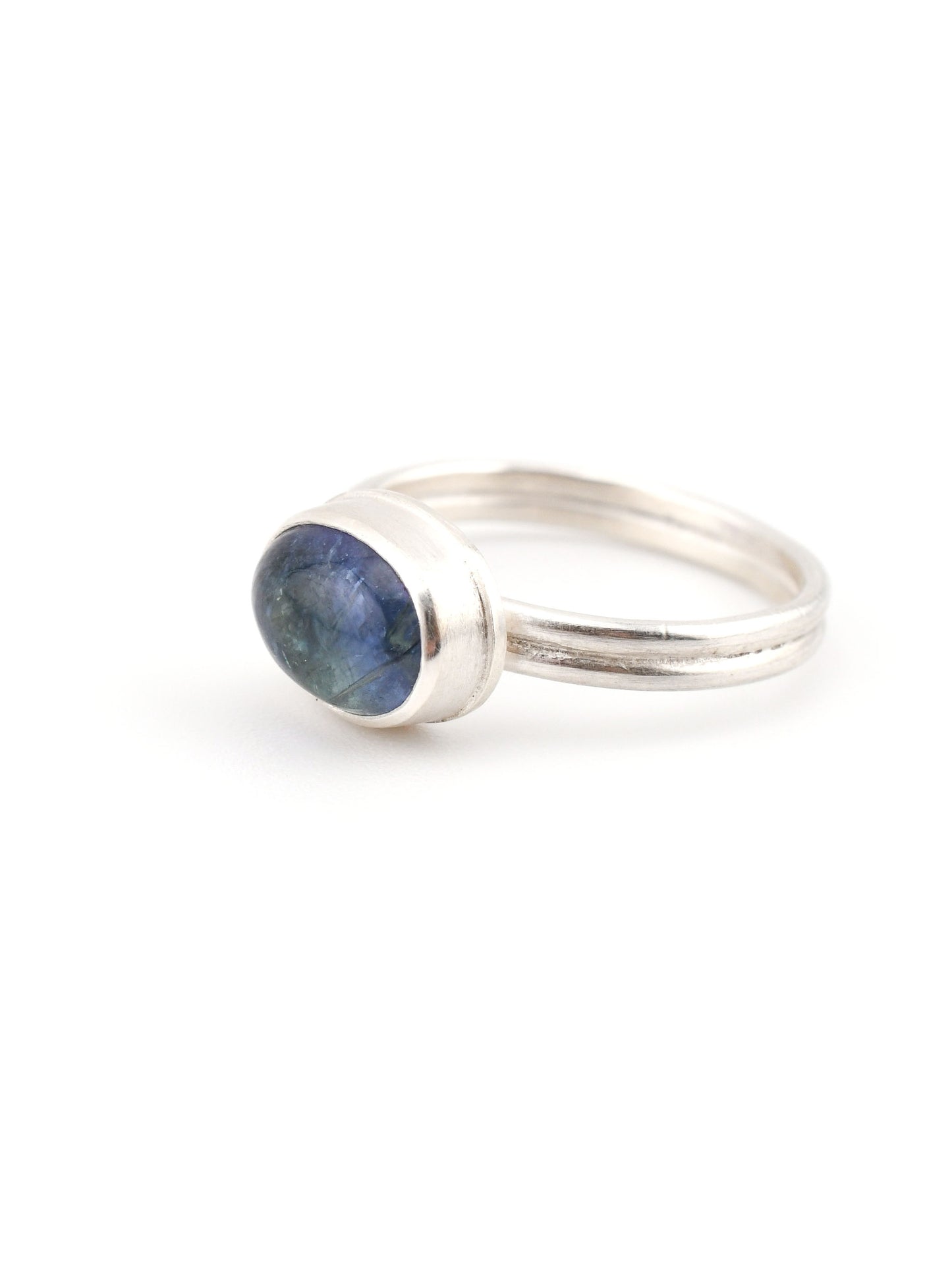 Silver ring with a blue stone on a white background