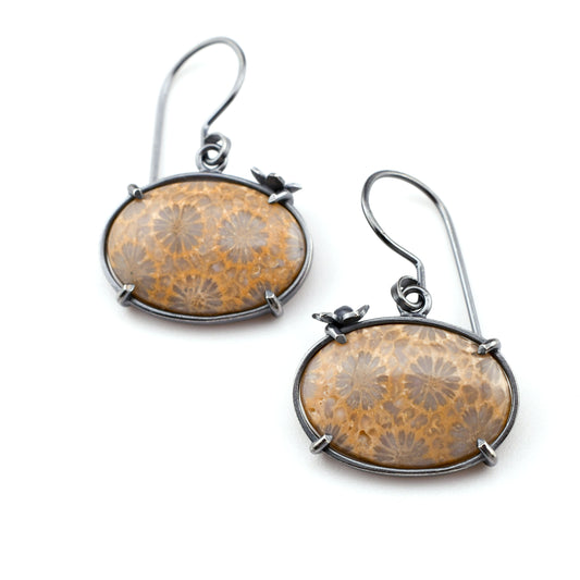 Pair of earrings with floral design on a white background