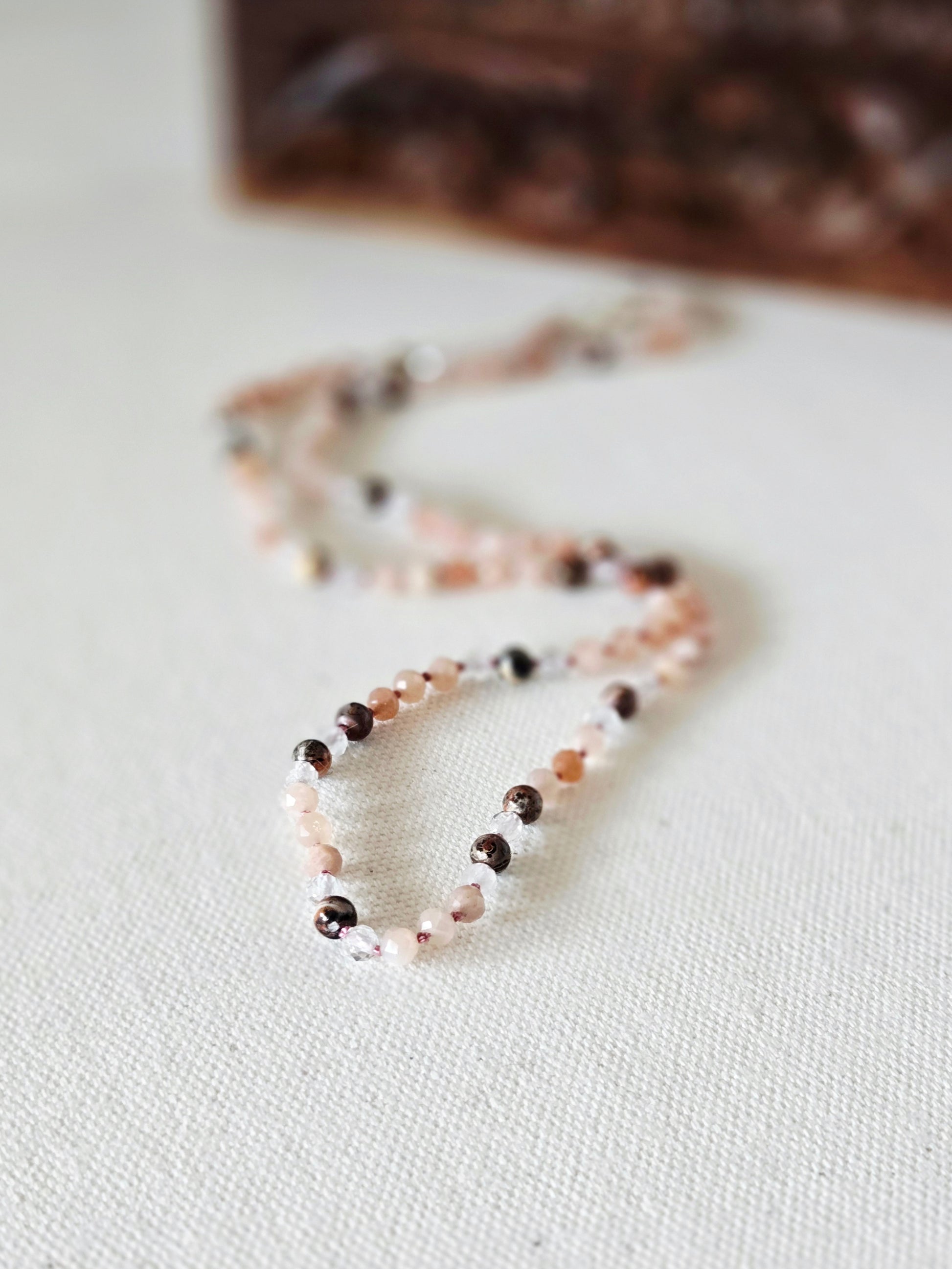beaded necklace on light background