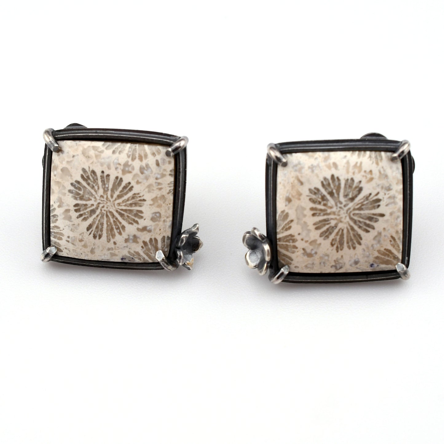 white square stones with floral design on a bright white background
