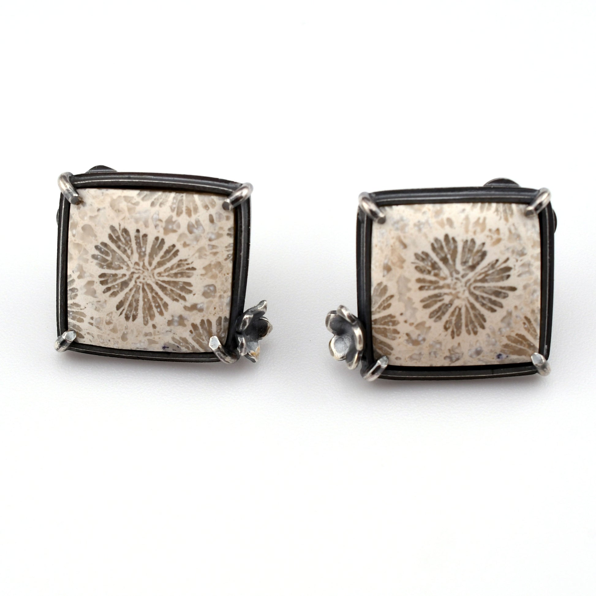 white square stones with floral design on a bright white background