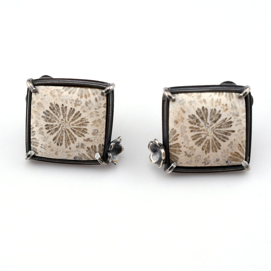 white square stones with floral design on a bright white background