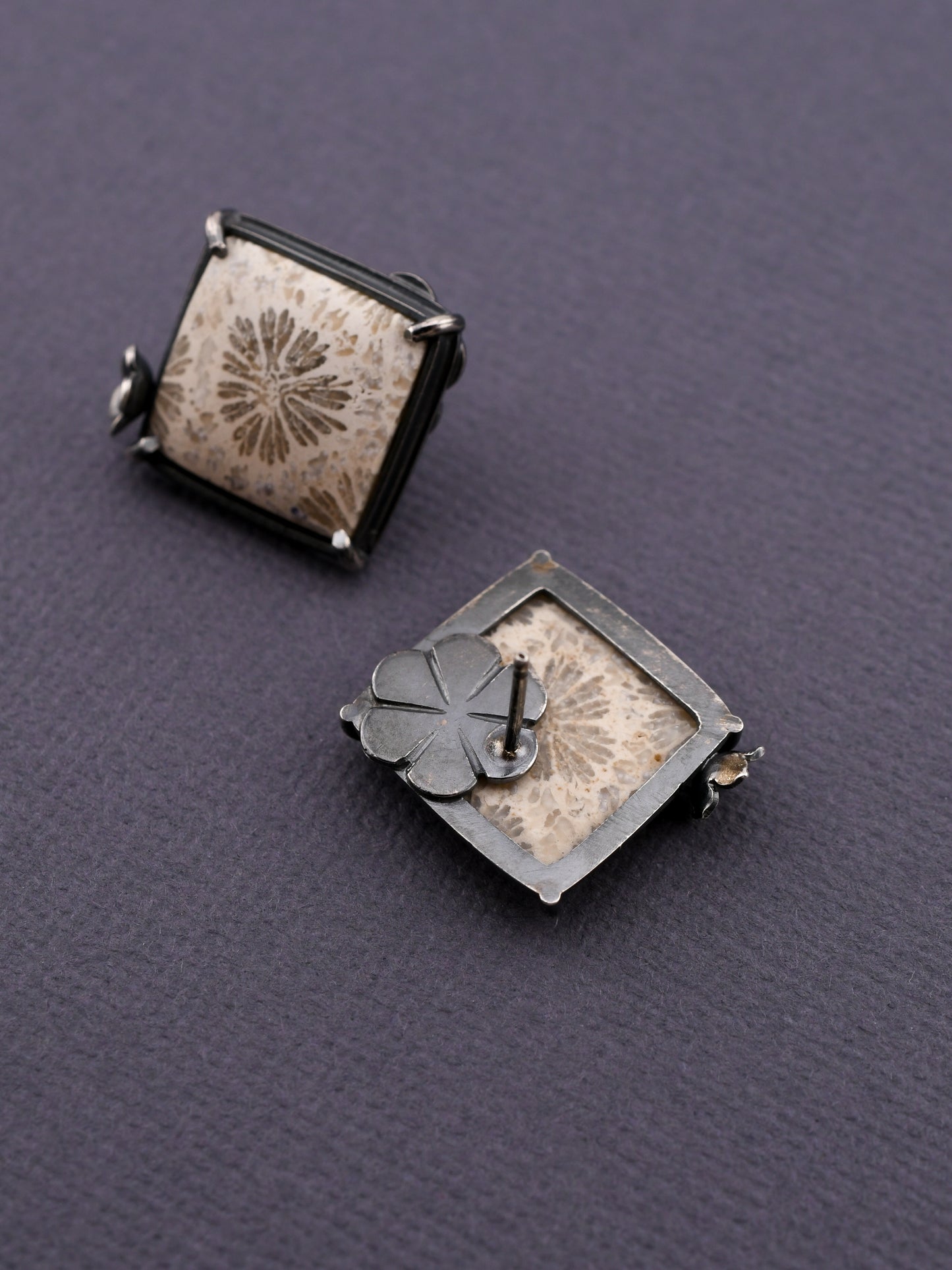 square stud earrings showing the back on a dark gray background