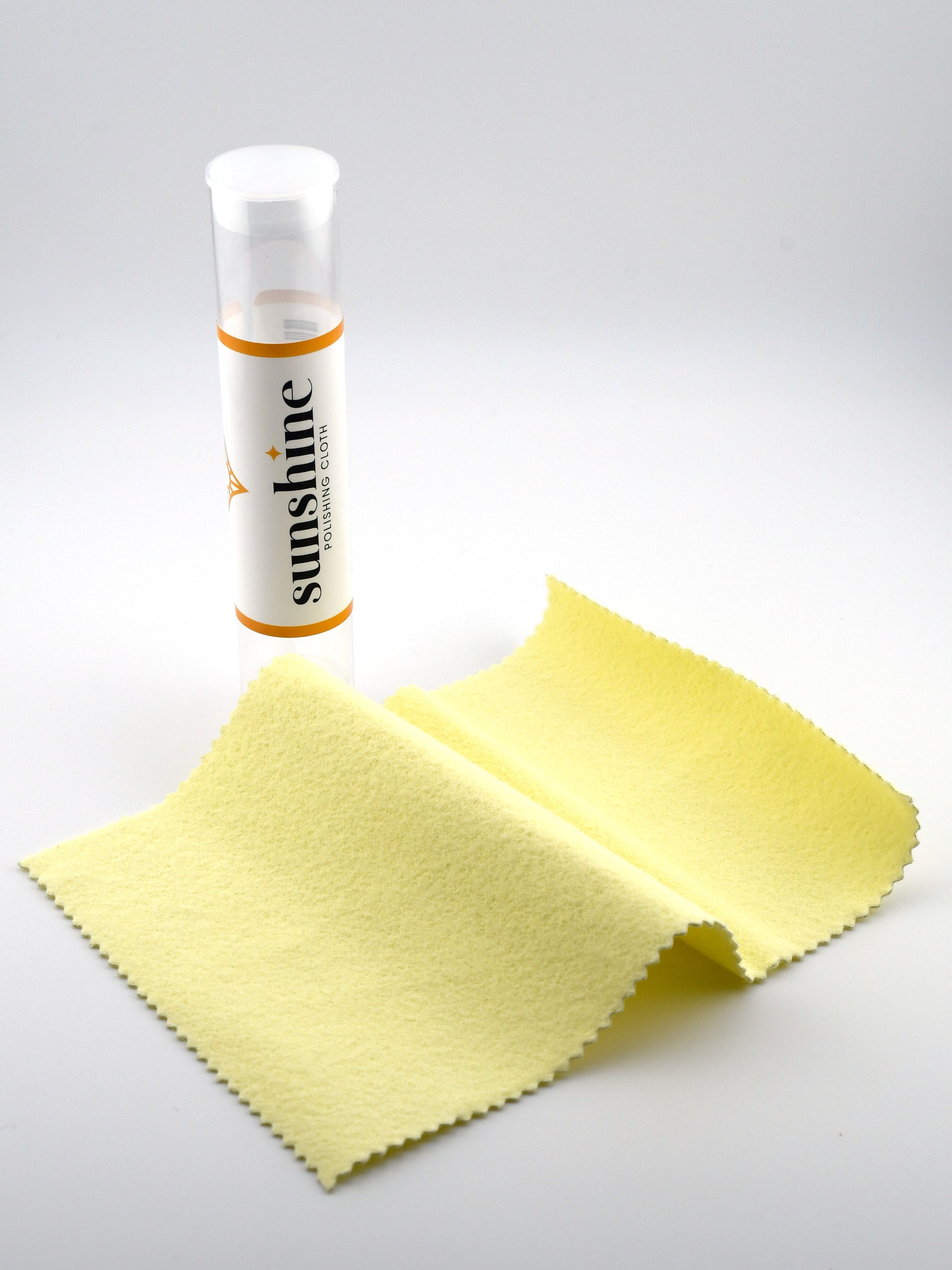 Sunshine brand travel tube and microfiber cloth on a white background with 
